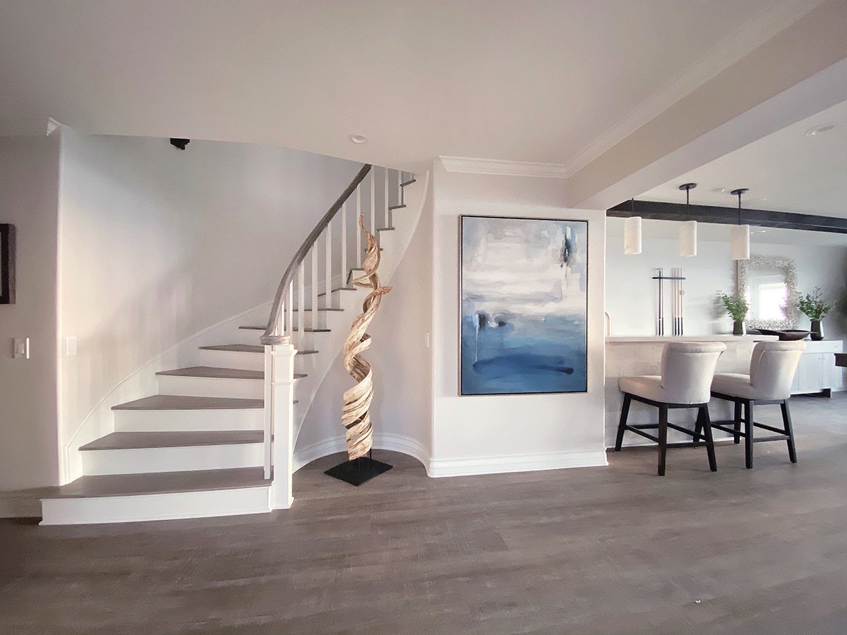 Transitional Beach House Entry Design with custom wood sculpture and leading into the game room.