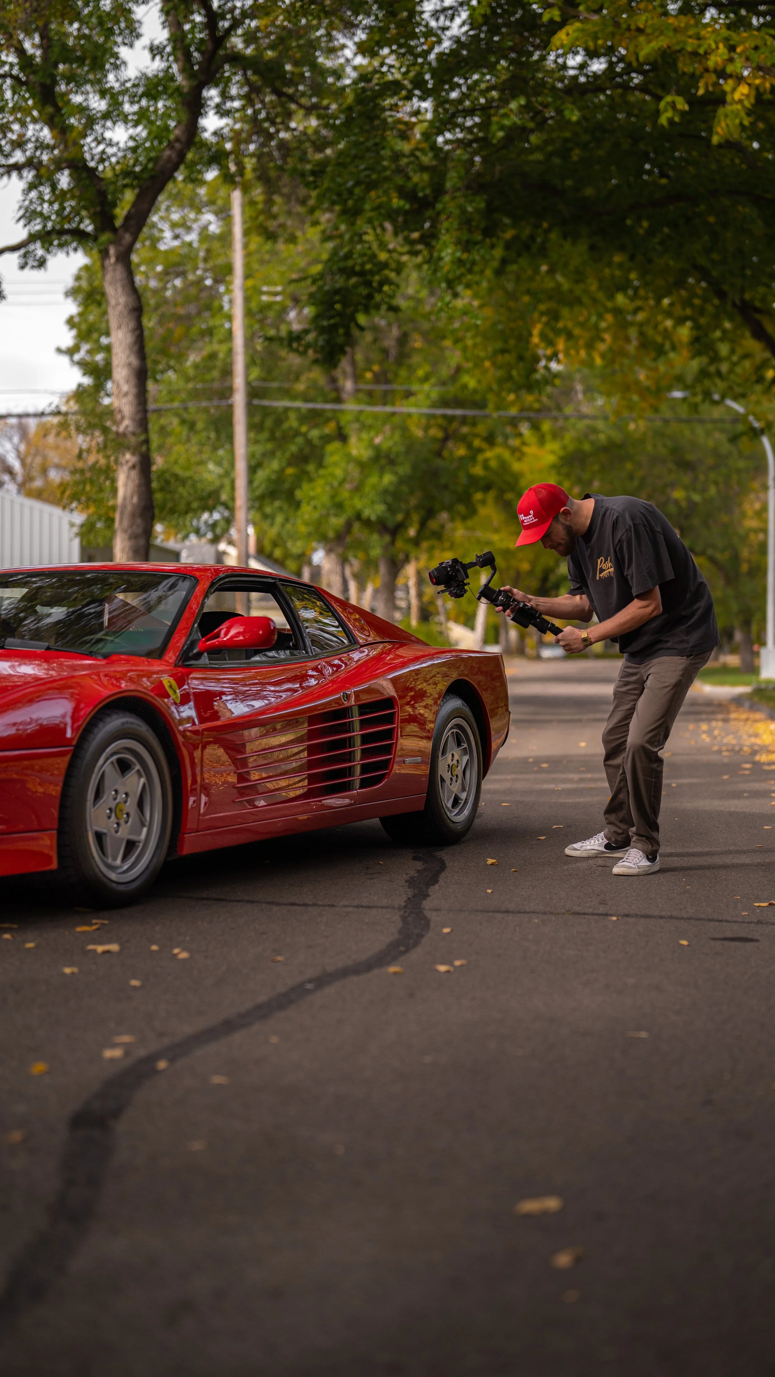 Zach Goerzen, founder of ZG media filming a Ferrari Testarossa.
