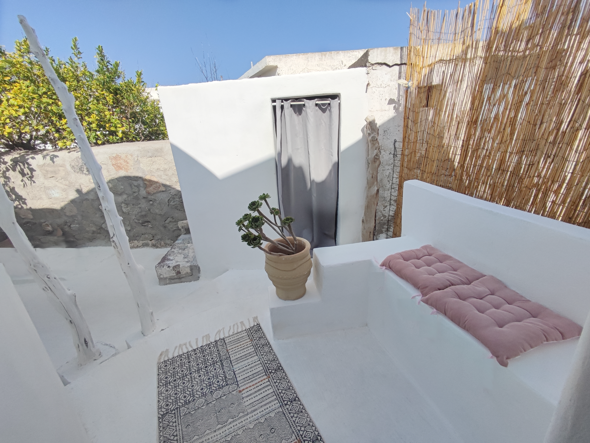 Inviting outdoor terrace of our Milos cave suite, a perfect spot to enjoy the serene beauty of Greece.