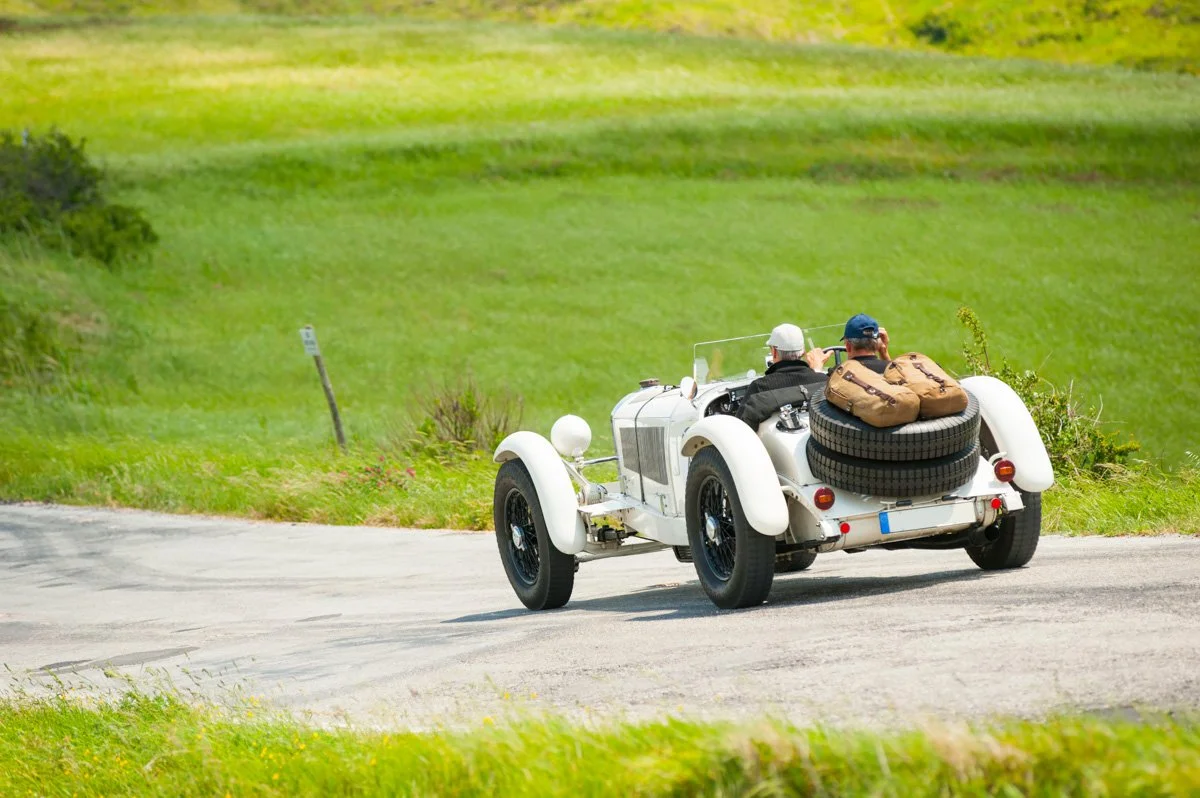 Vintage convertible old car driving on open country road
