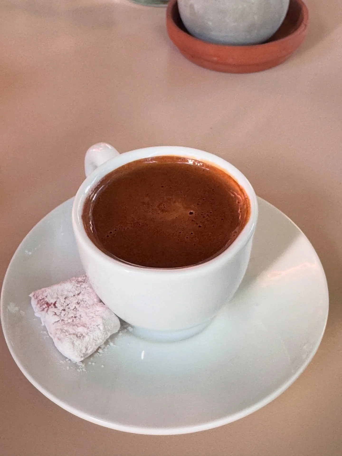 This is something rare but if you ever experience it it will travel you back to your past. A cup of Greek coffee accompanied by a piece of powdered sugar-coated delight.