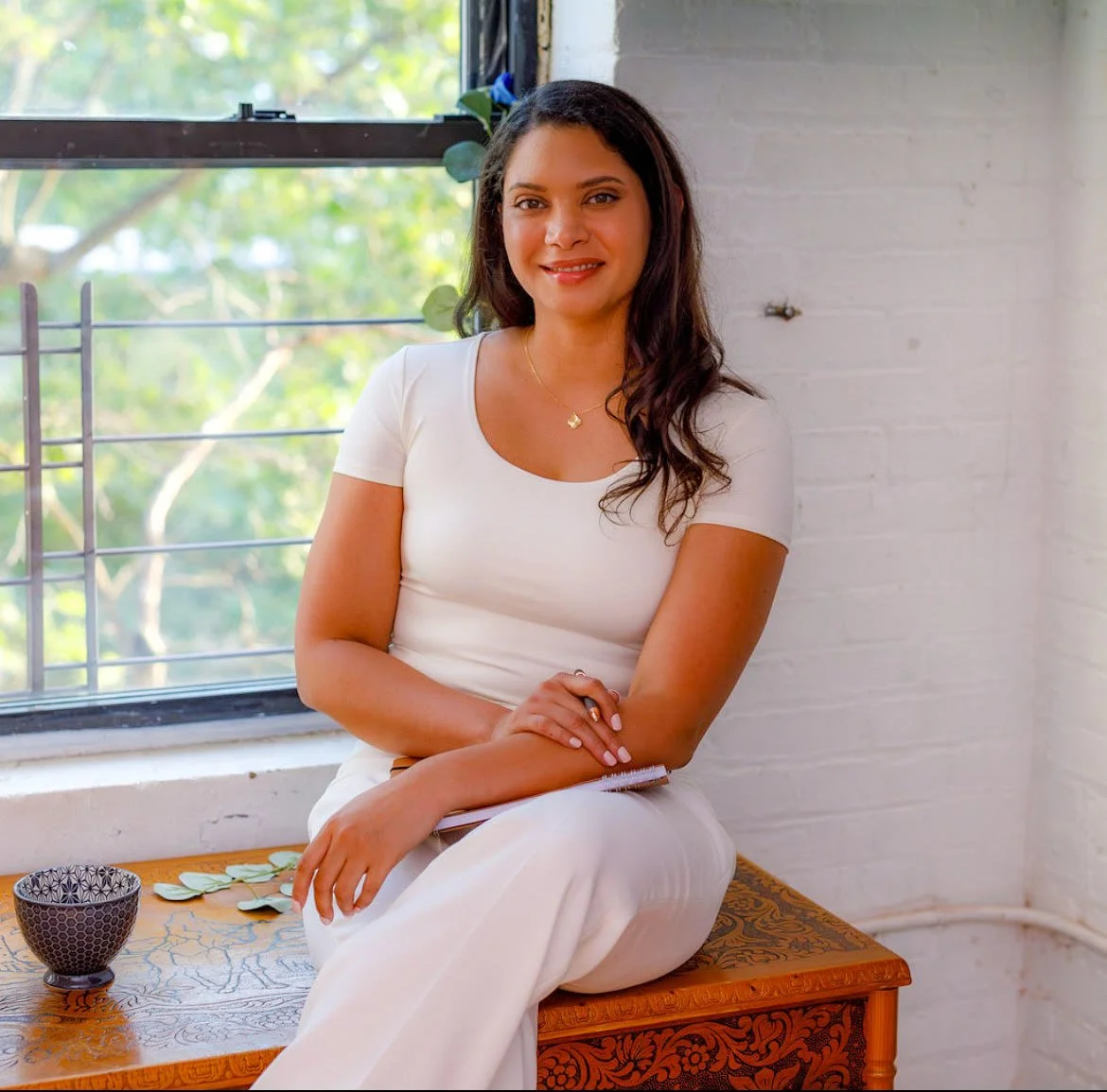 Alexis, a grief therapist, smiling at camera