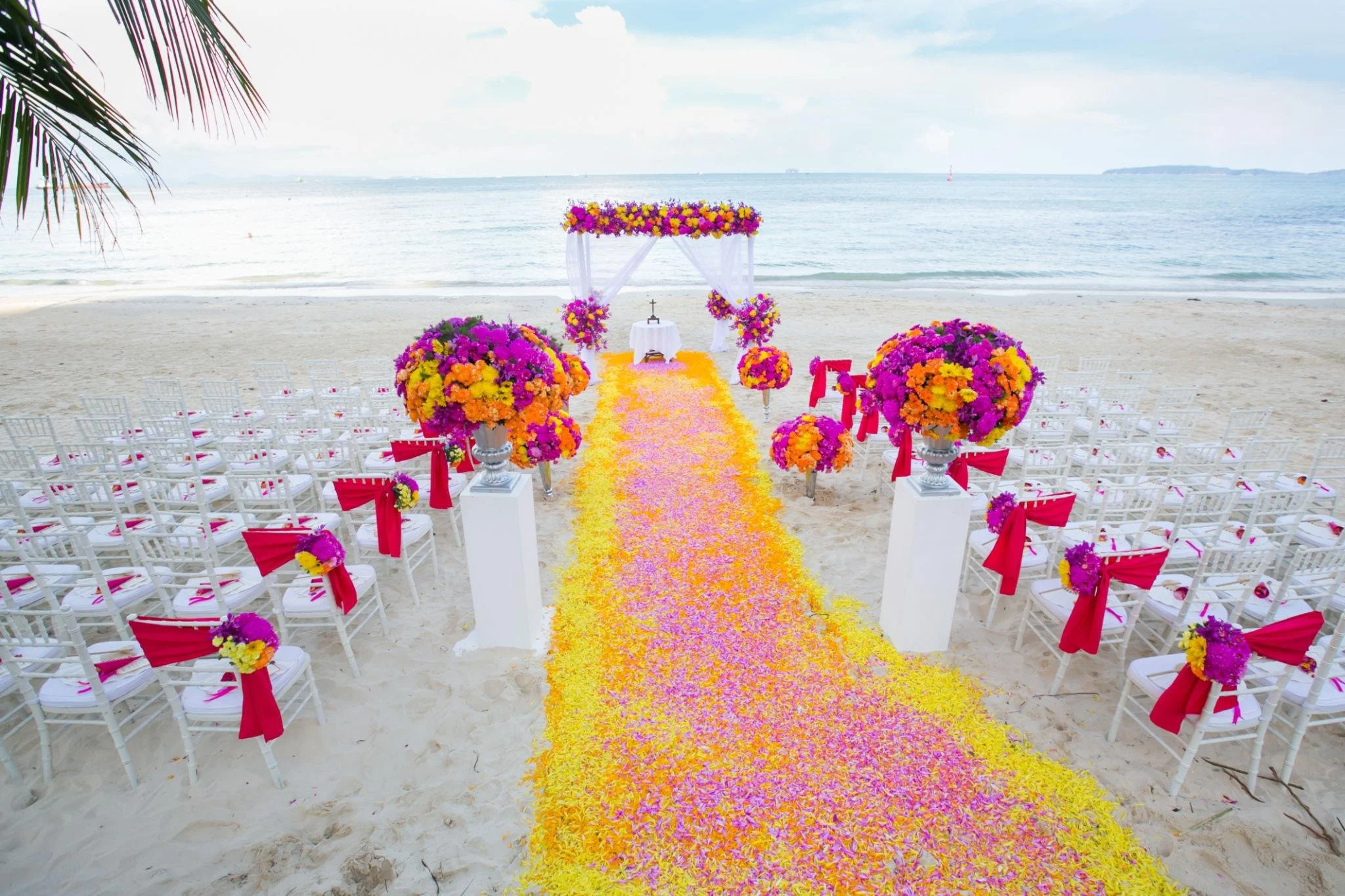 Ceremony on Beach, white Chairs, Colorful Floral Decor