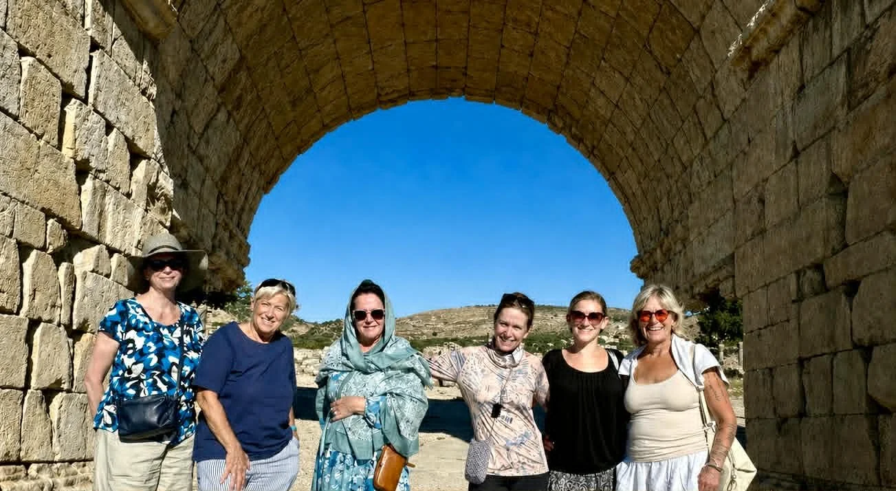 group of six women posing while on a cultural experience day trip.