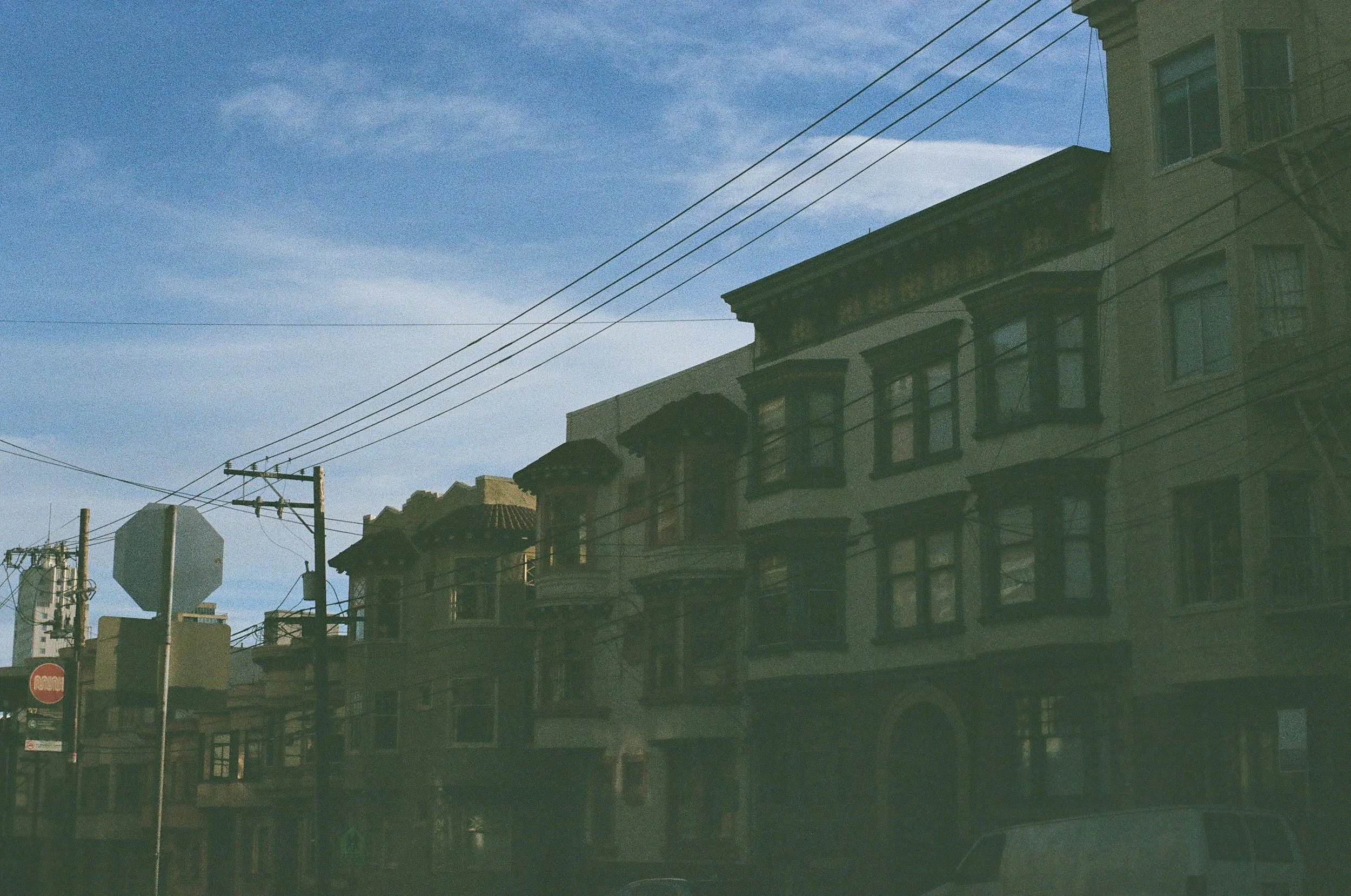 Film photo of blue sky and the outside an office in downtown Guelph providing trauma therapy for people-pleasing in Ontario