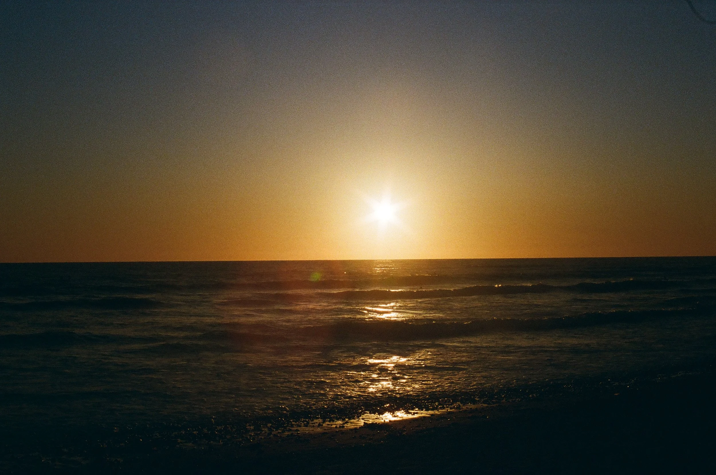 A sunset over water representing the calm therapy for grief in Guelph Ontario can bring