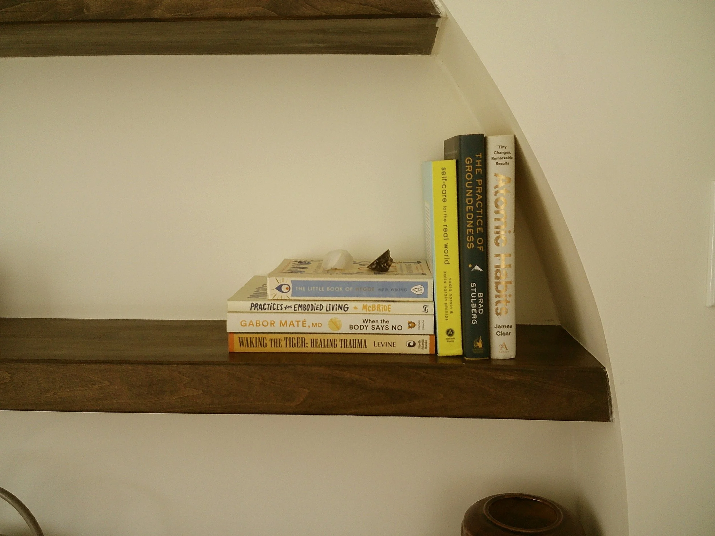 A bookshelf with 7 books in a Guelph ADHD therapist's Ontario counselling office.