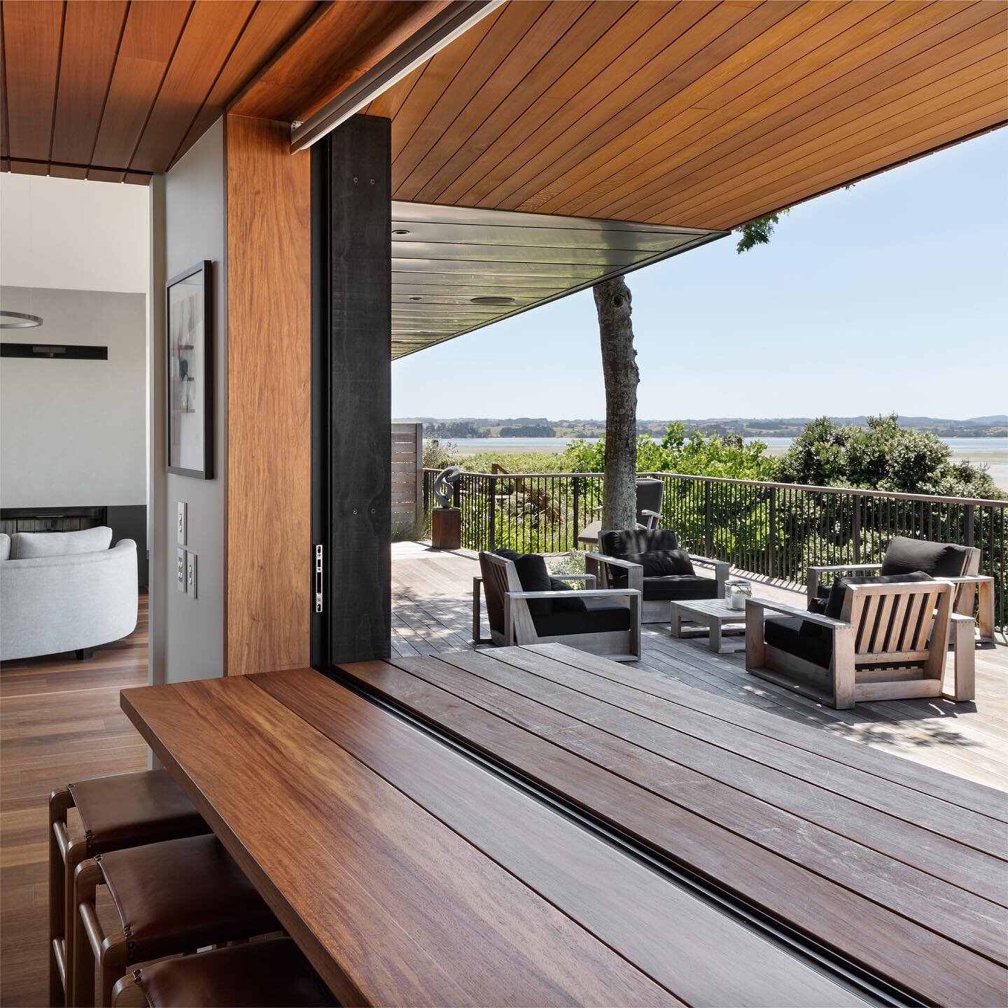 Seaside Barn &mdash; Kitchen servery window framed in rosewood timber offering views of the Manukau Harbour.