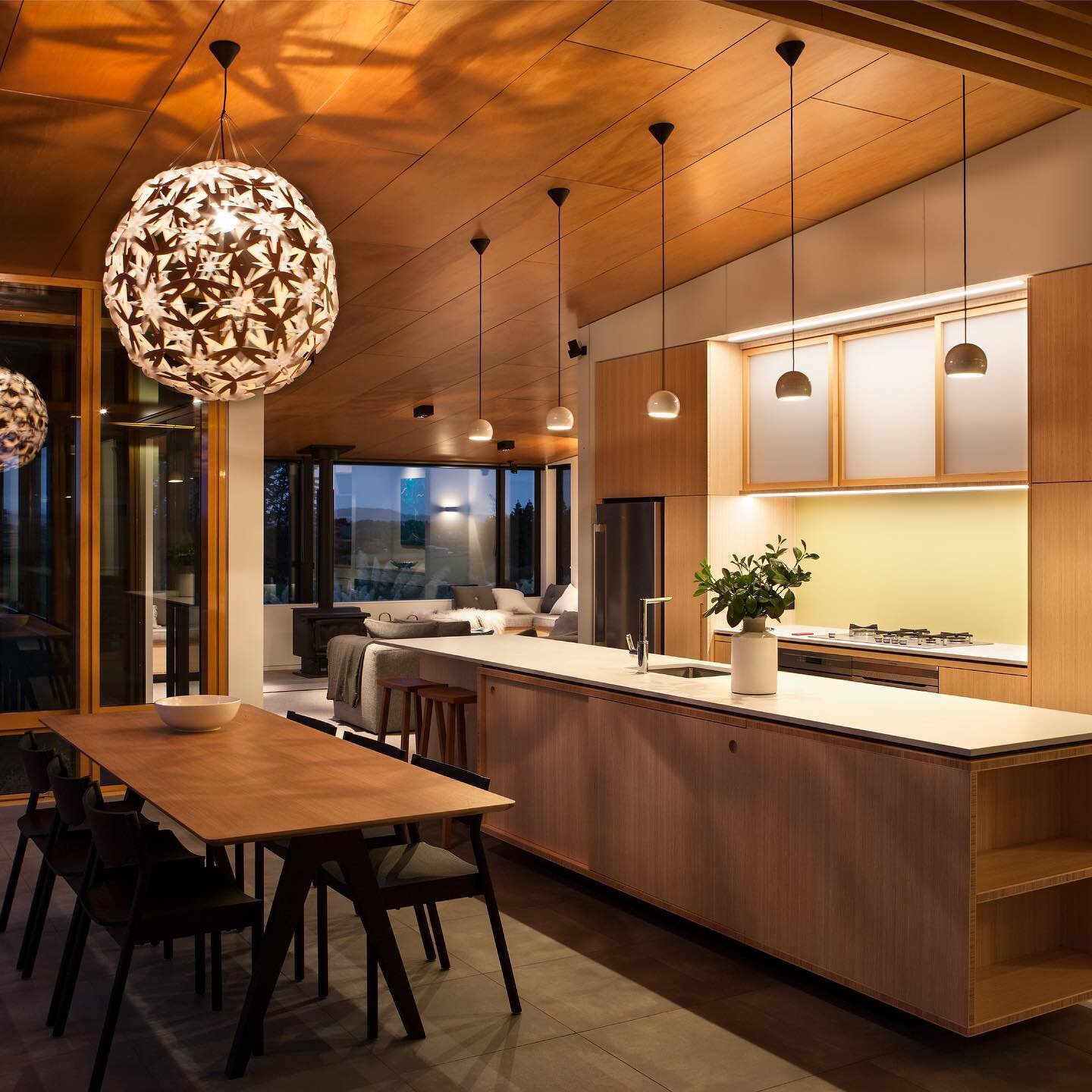 Te Hihi Home &mdash; Great shot of this beautiful kitchen and its stunning features: the Fijian Kauri plywood ceilings and bamboo paneling! The warm and natural tones of the wood bring a cozy and inviting feel to the space.