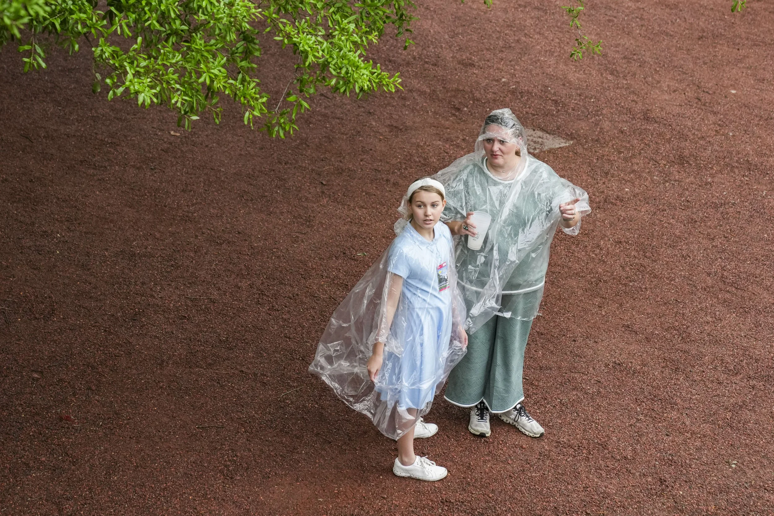 Patrons wear ponchos behind the grandstands at Amen Corner during the first round of the Masters Tournament at Augusta National Golf Club in Augusta, Ga., on Monday, April 7, 2025. Mandatory Credit: Grace Smith-Imagn Images