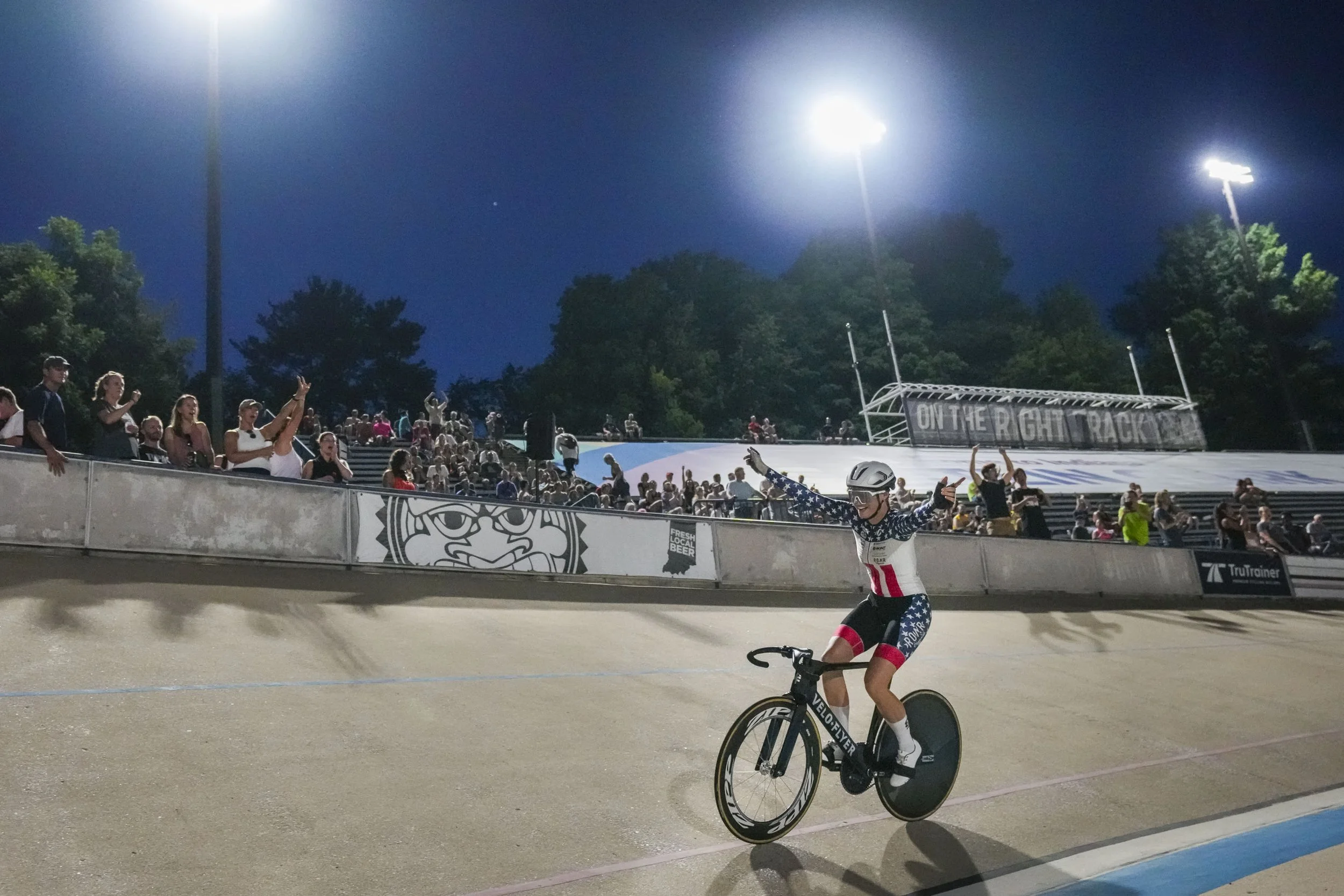 Stephanie Lawrence celebrates winning a race during BikeParty Indianapolis’ Track Night at Major Taylor Velodrome in Indianapolis, Ind., on Friday, Aug. 8, 2025. Once a race starts, Lawrence transforms into a contender at the highest level. “She does