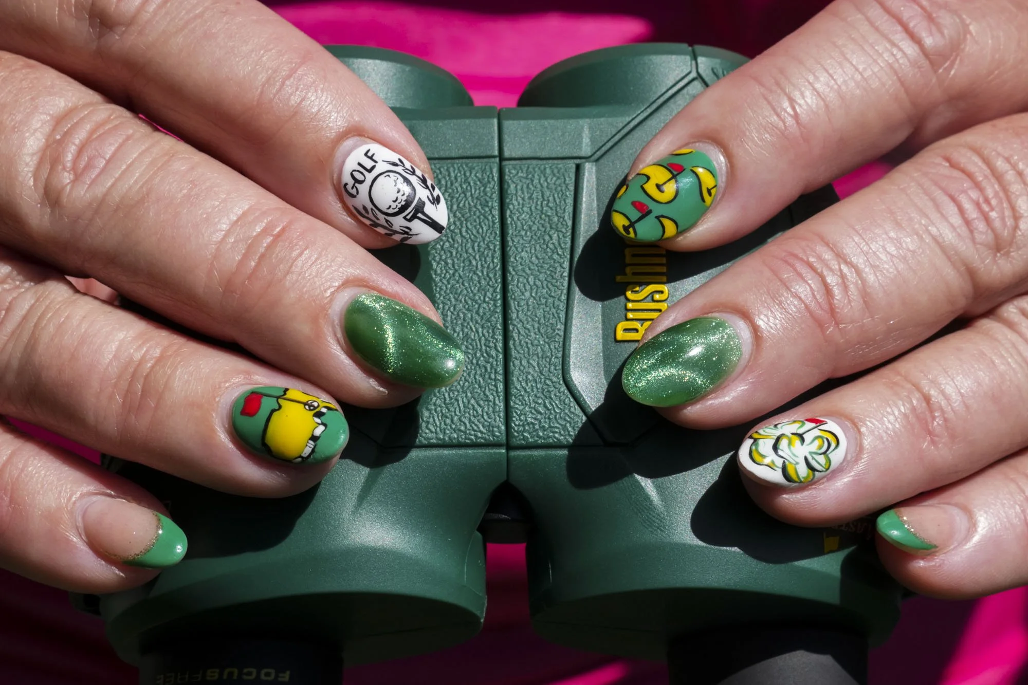 Stephanie Haywood, 48, of Knoxville, Tenn., shows off her Masters-themed nails near the 14th tee Friday, April 10, 2026, during the second round of the Masters Tournament at Augusta National Golf Club. Mandatory Credit: Grace Smith-Imagn Images