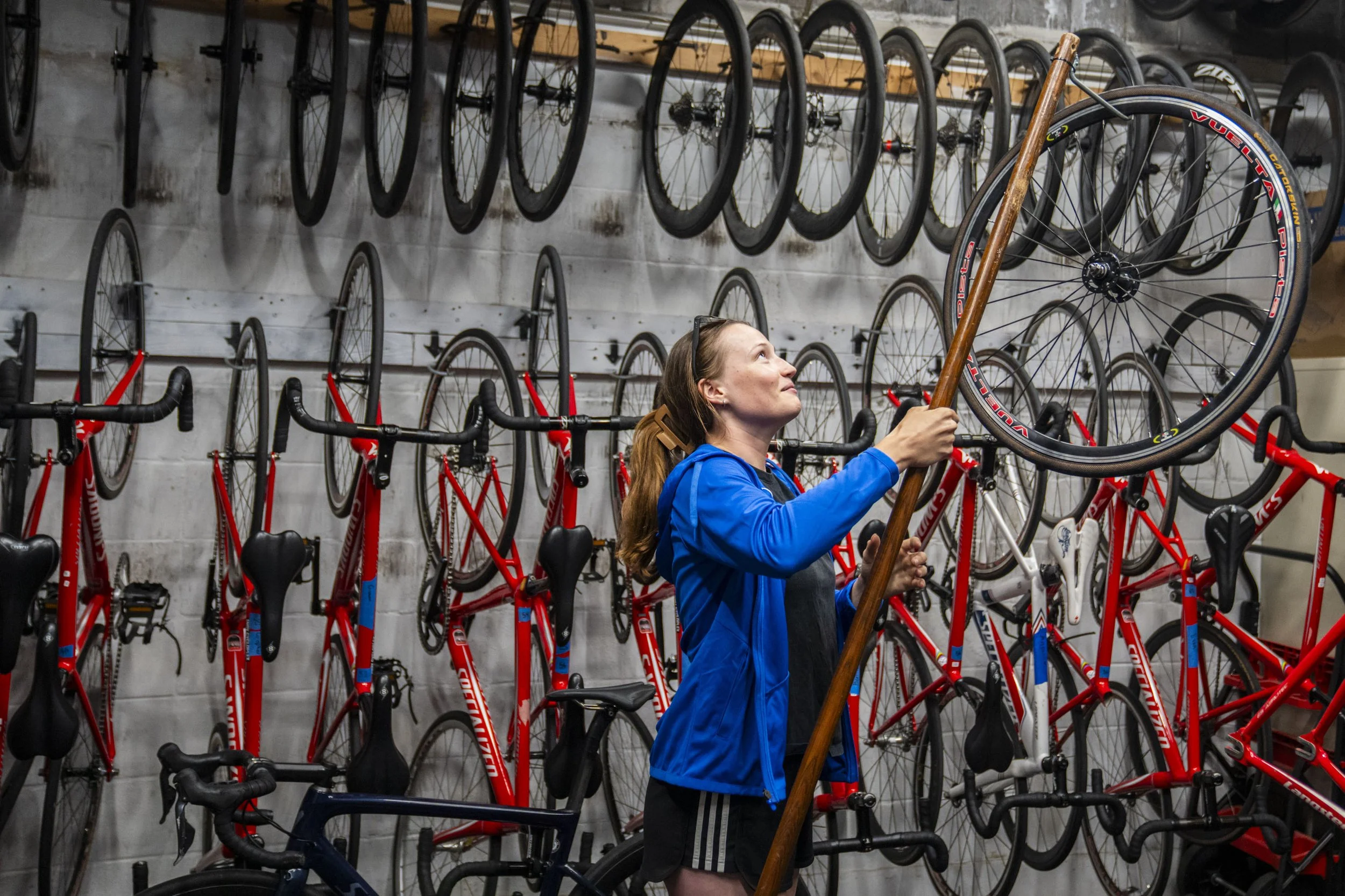 Stephanie Lawrence moves wheels around while working before a race at Major Taylor Velodrome in Indianapolis, Ind., on Thursday, June 5, 2025. When her dad wasn’t racing around the track during Lawrence’s childhood, the duo would watch races from the