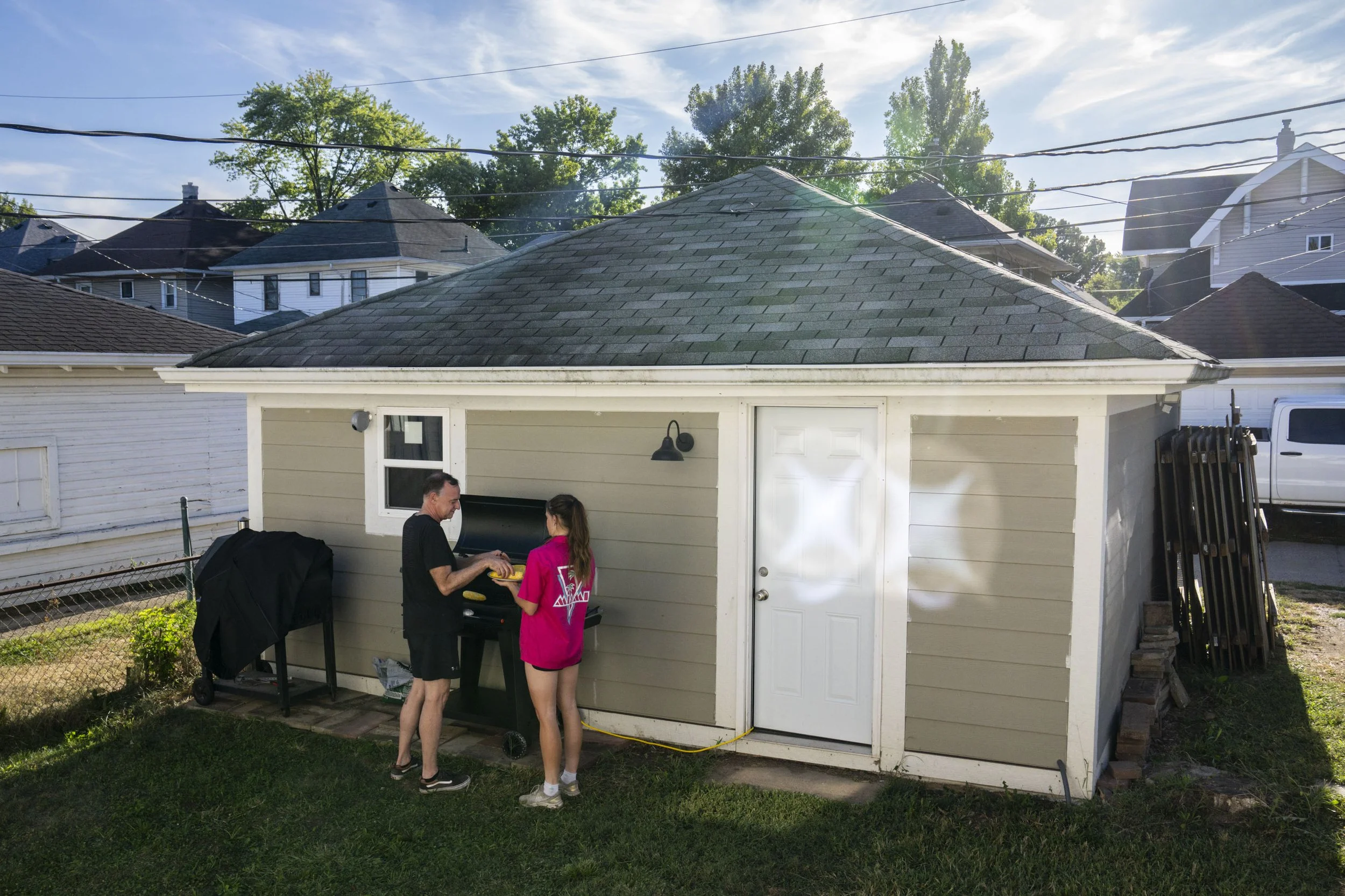 Stephanie Lawrence and her dad Jim Lawrence add corn on the cob to the grill at Stephanie’s home in Indianapolis, Ind., on Sunday, Aug. 31, 2025. Lawrence attributes her speed and success to her support system at Marian, her coaches and her family. T