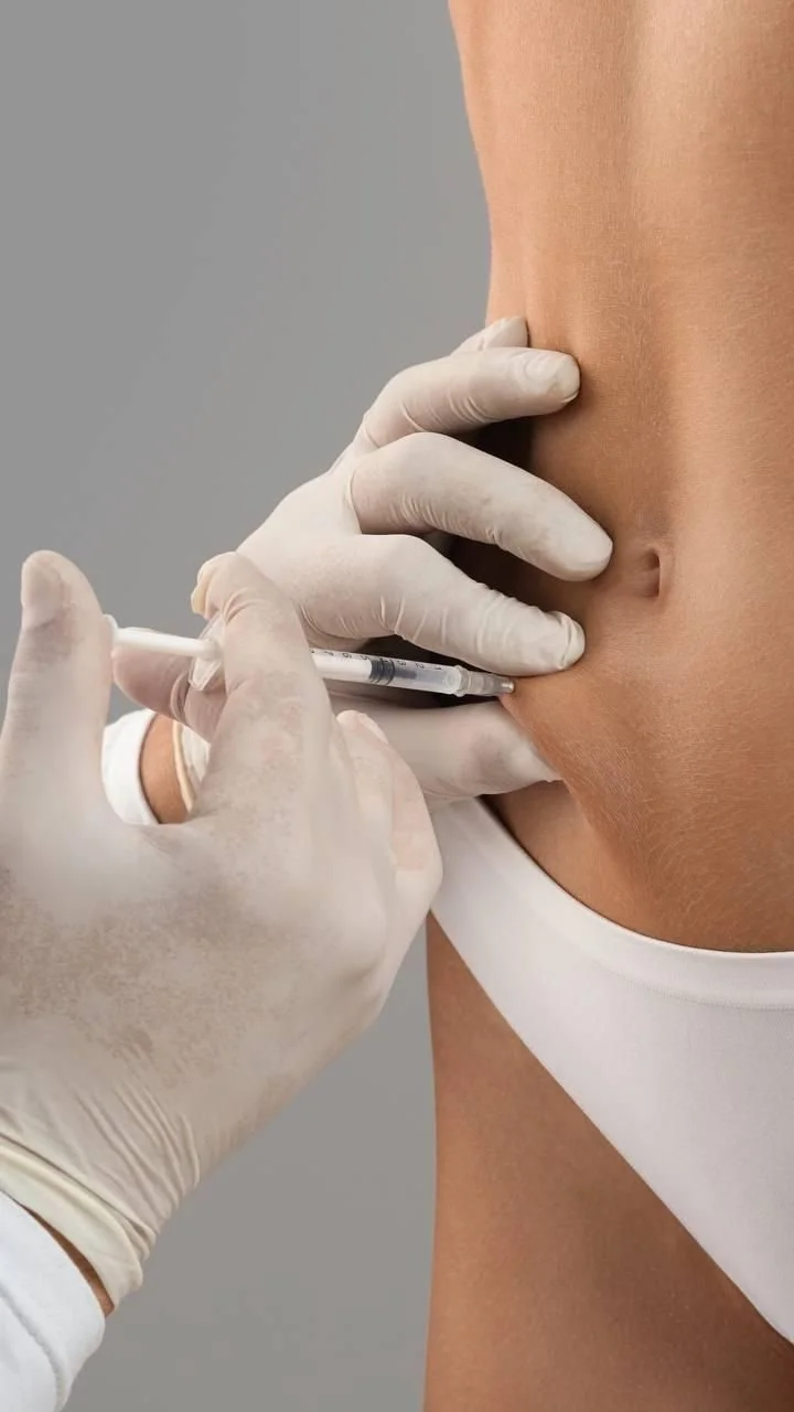 Person receiving a vaccination in their upper arm from a healthcare professional wearing gloves.