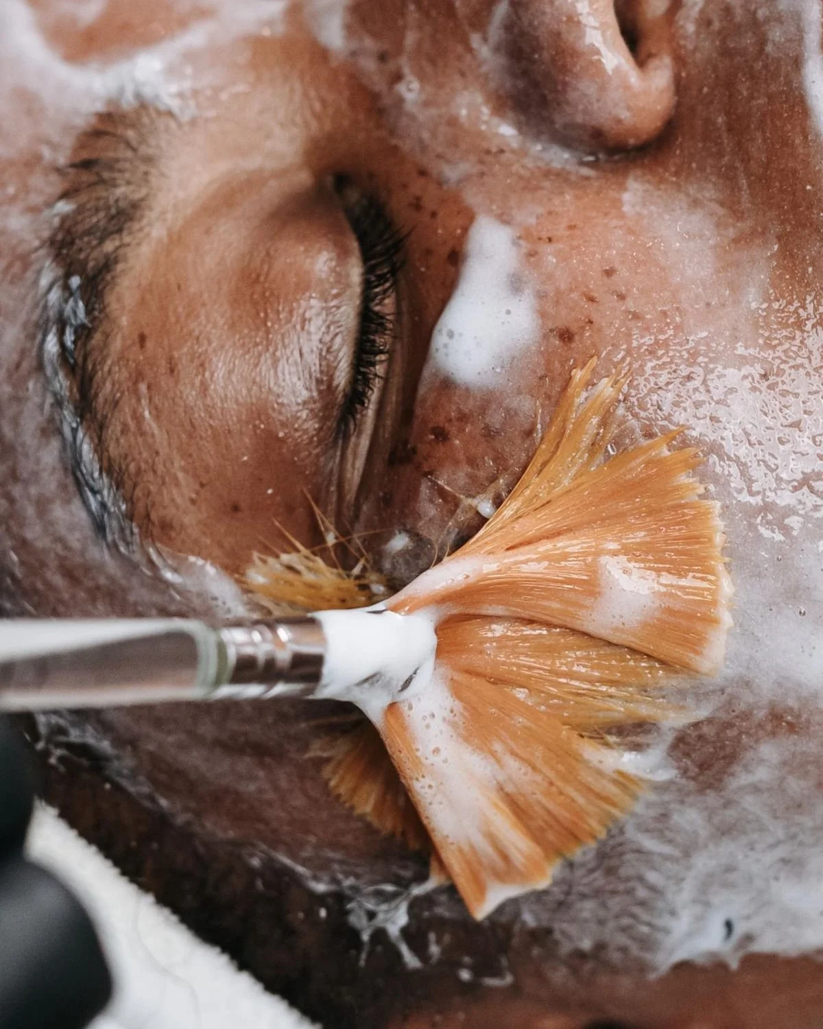 Close-up of a person receiving an ear examination using a specialized tool.