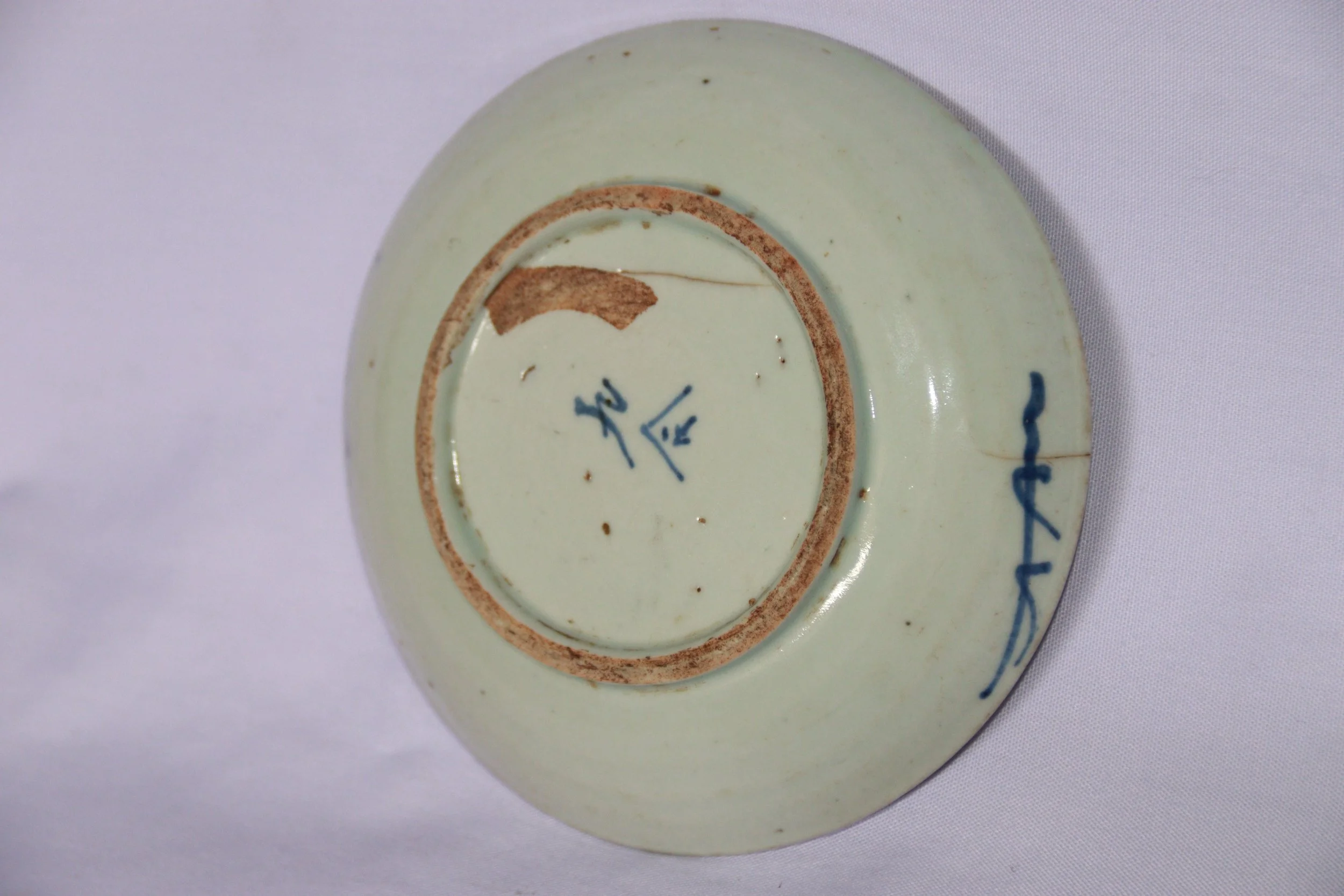 archive number: r-2-024
object reference: 
Qing-style plate
origin: China (assumed)
date: Qing Dynasty
notes: This plate is made of ceramic, predominantly white with a blue motif. The main motif is a pattern of overlapping circles or scales, creating