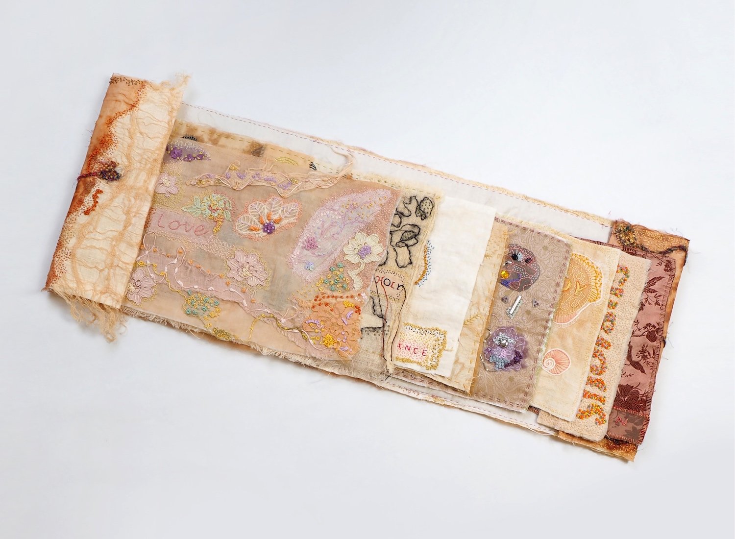 Book of feeling (open layout), 2021. Embroidery and drawn thread work on onion skin dyed silk organza and linen. 1000mm x 280mm. Photograph Jae Criddle.