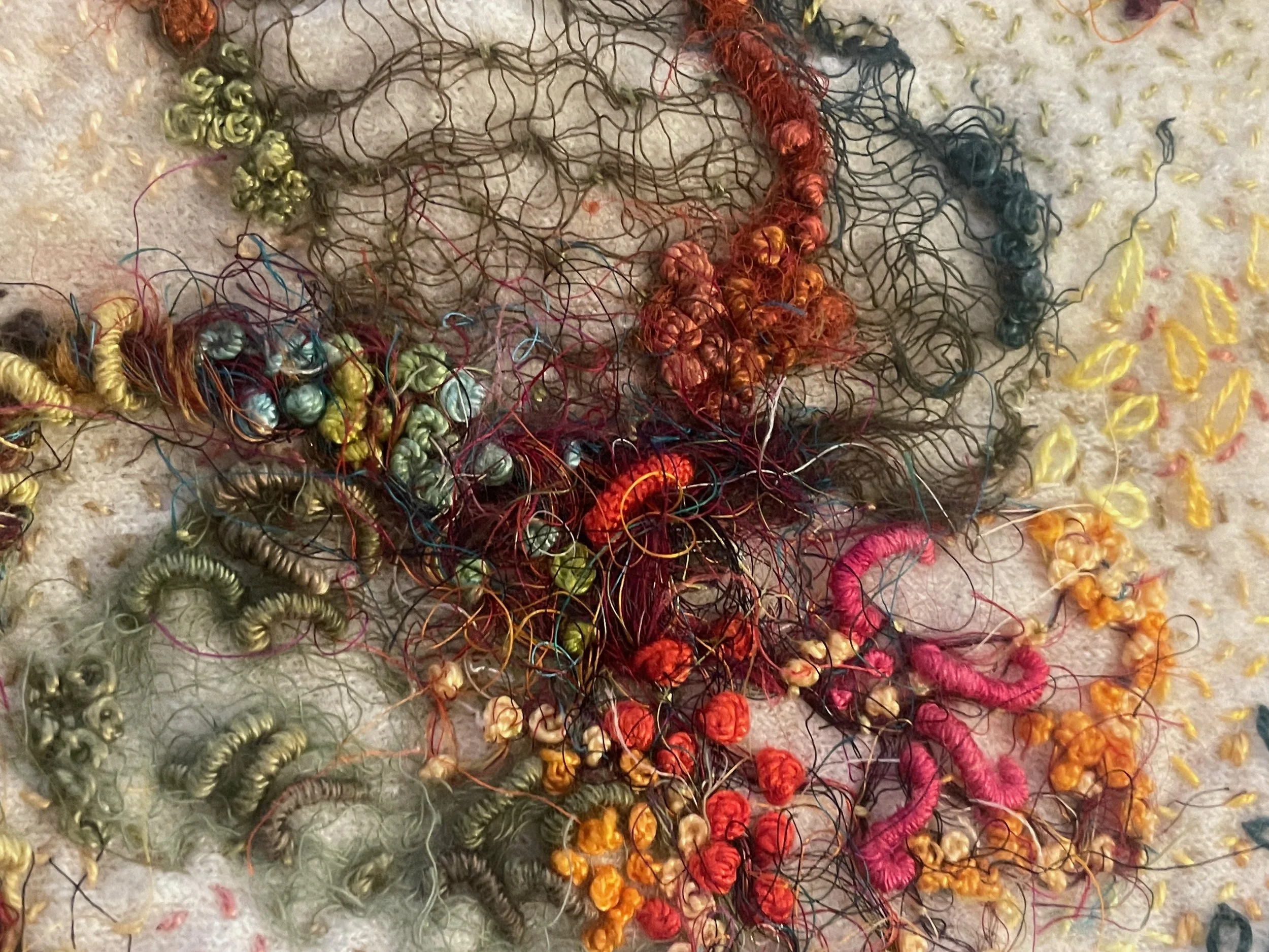 Shrunk, (detail) 2025. Artist's discarded shrunken felted wool cardigan, silk scraps, silk fibre, recycled sari silk thread, cotton and silk scrim, gimp, mulberry bark and assorted silk and cotton embroidery threads. Photography Joy Denise Scott.
