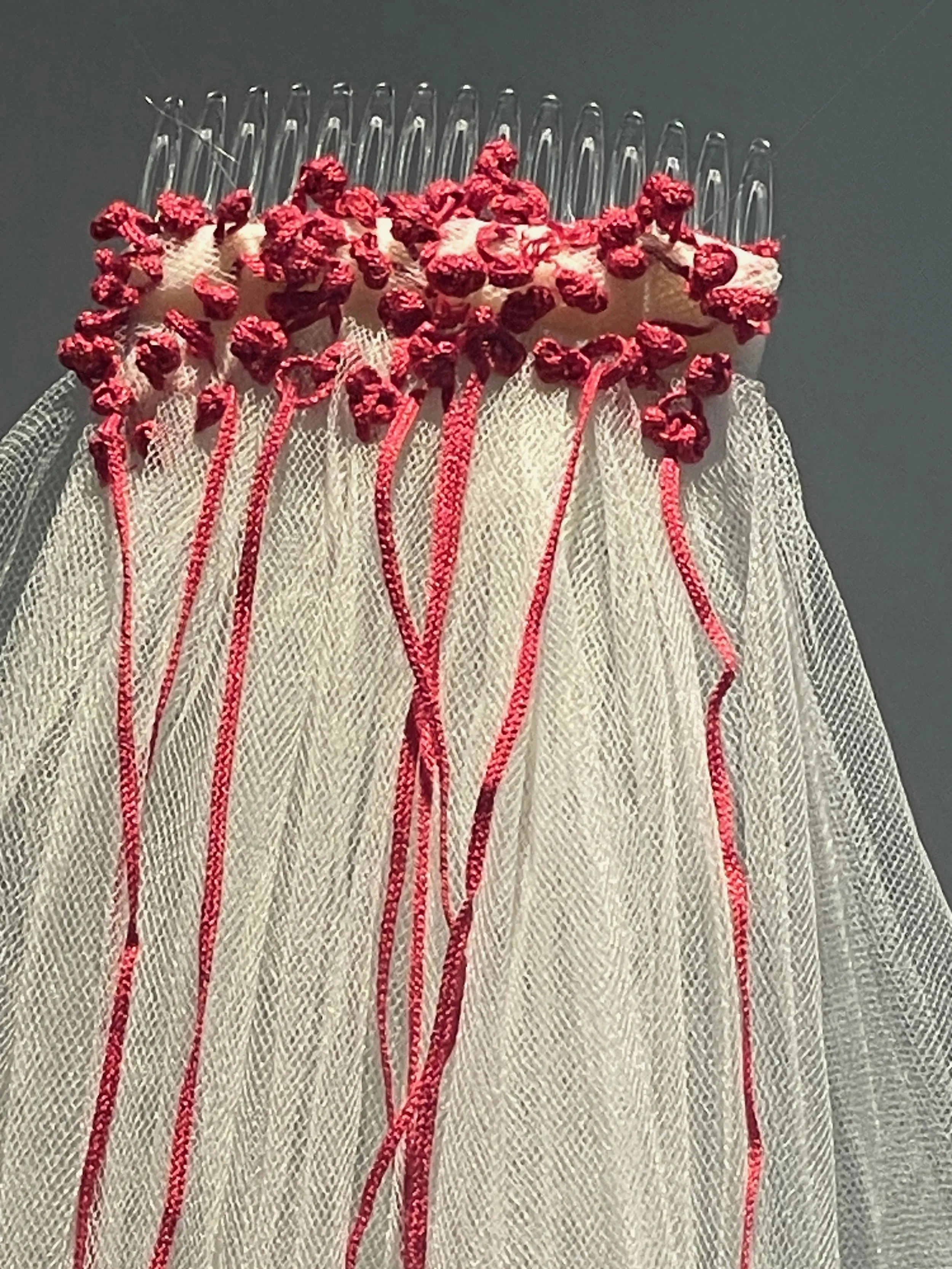 White wedding... a departure from what has gone before (detail), 2026, Improvisational embroidery and appliquéd mulberry bark on discarded net veil. Photography Joy Denise Scott