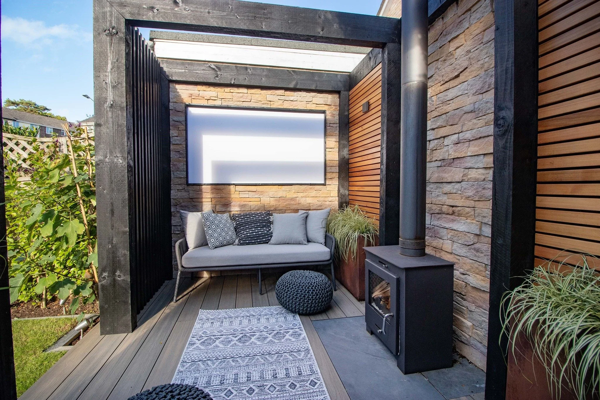 🔥 Garden snug mode: activated.

This custom outdoor retreat by Creating Spaces blends comfort, texture and warmth &mdash; complete with a feature stove, soft seating, and layered natural materials. A perfect hideaway for cooler evenings, cosy chats,