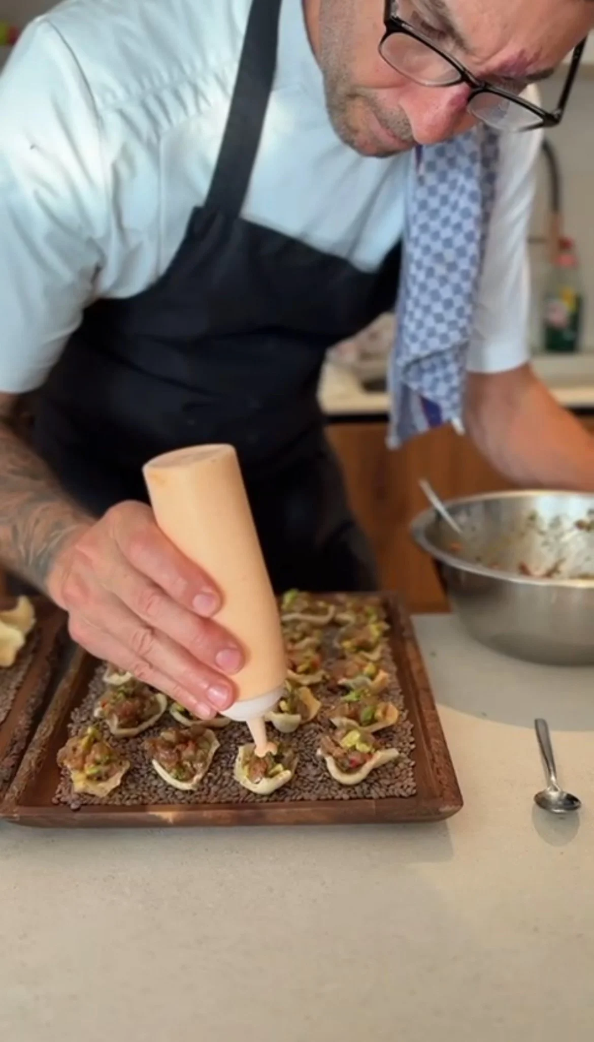 Private chef in Mallorca plating a fine dining appetiser with precision during a luxury private dining experience