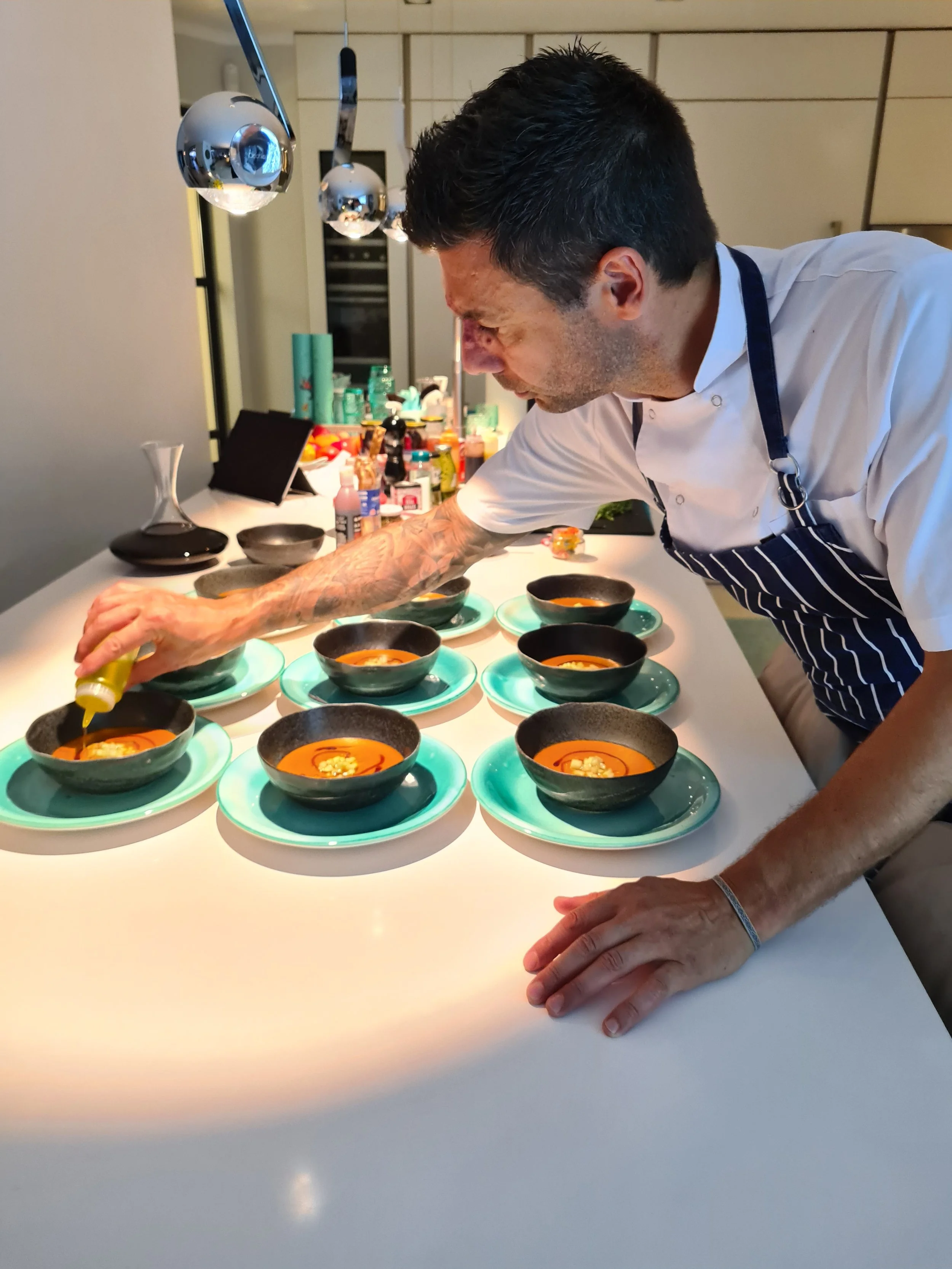 Private chef in Mallorca plating a fine dining dish for a luxury private dining experience
