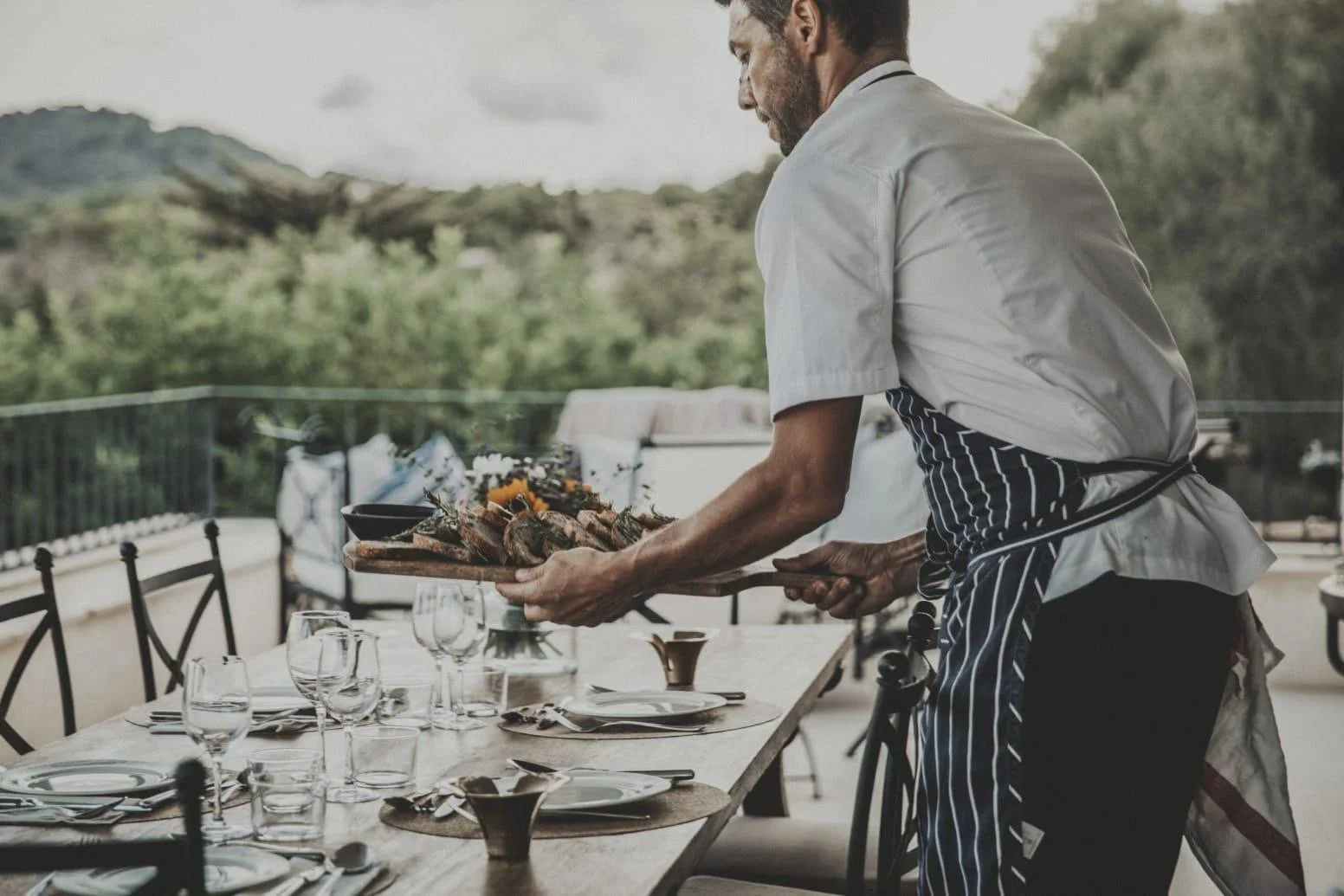 Private chef in Mallorca serving a luxury villa dinner with elegant table setting