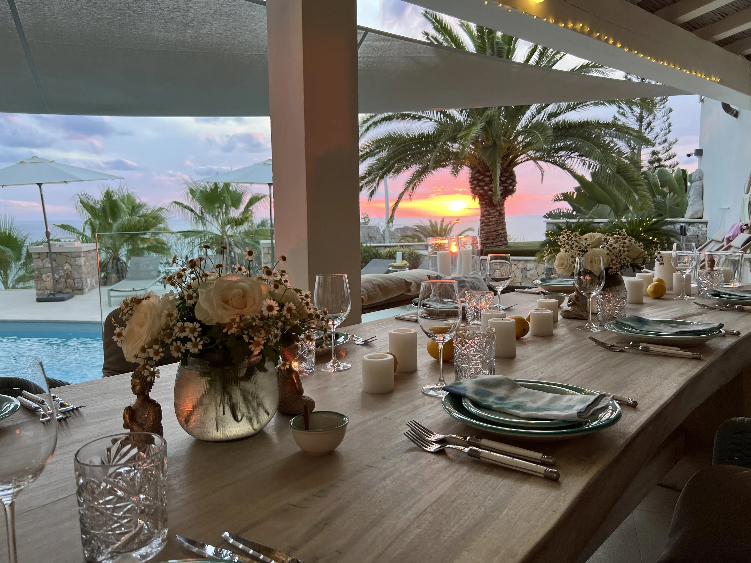 Luxury private chef table setting in a Mallorca villa at sunset, elegant fine dining experience by a private chef