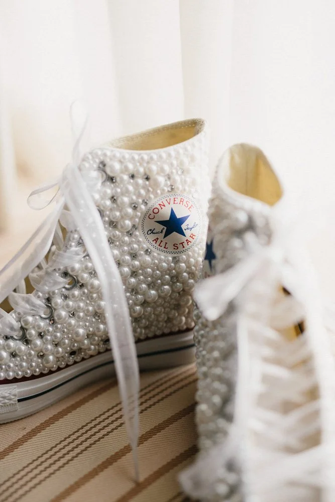 Brides custom converse sneakers surrounded in creamy white pearls at the Arctic Club Dome Room-Photography by GH KIM-planned and designed by Simply Wed