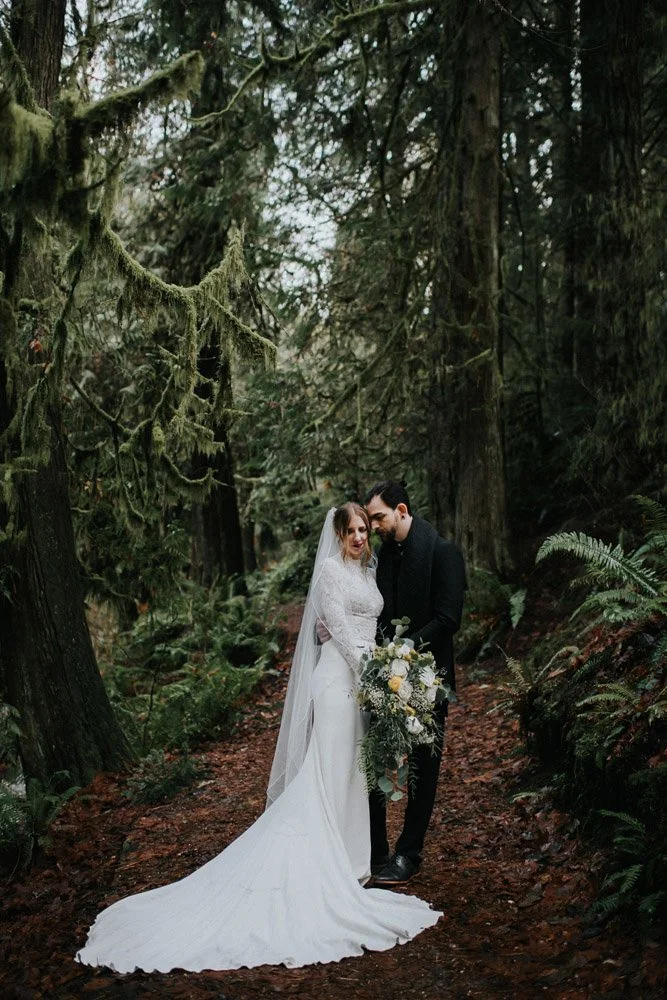 A very moody dark portrait of the bride and groom together outside in the woods at the Alderbrook Resort-Photography by Nick plus Danee Photography.-planned and designed by Simply Wed