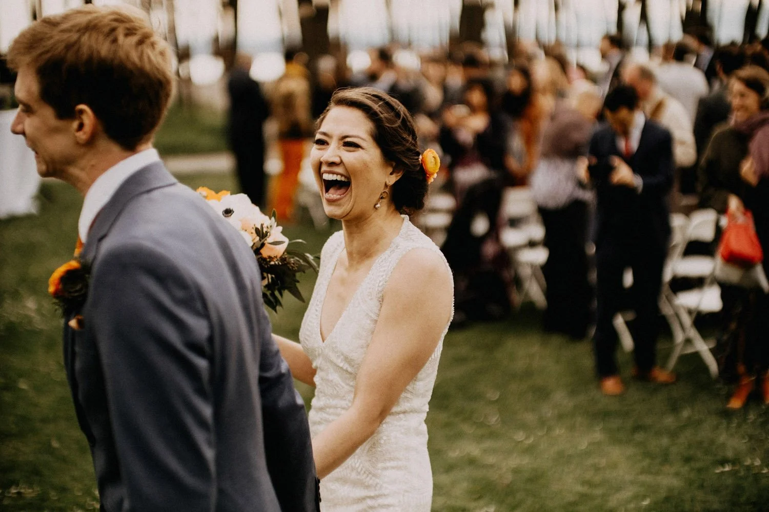 The bride walking with her new husband, mid laughter looking at him with love after the ceremony ends at the gorgeous Golden Gardens Bath House-Photography by Dylan M Howell Photography-planned and designed by Simply Wed