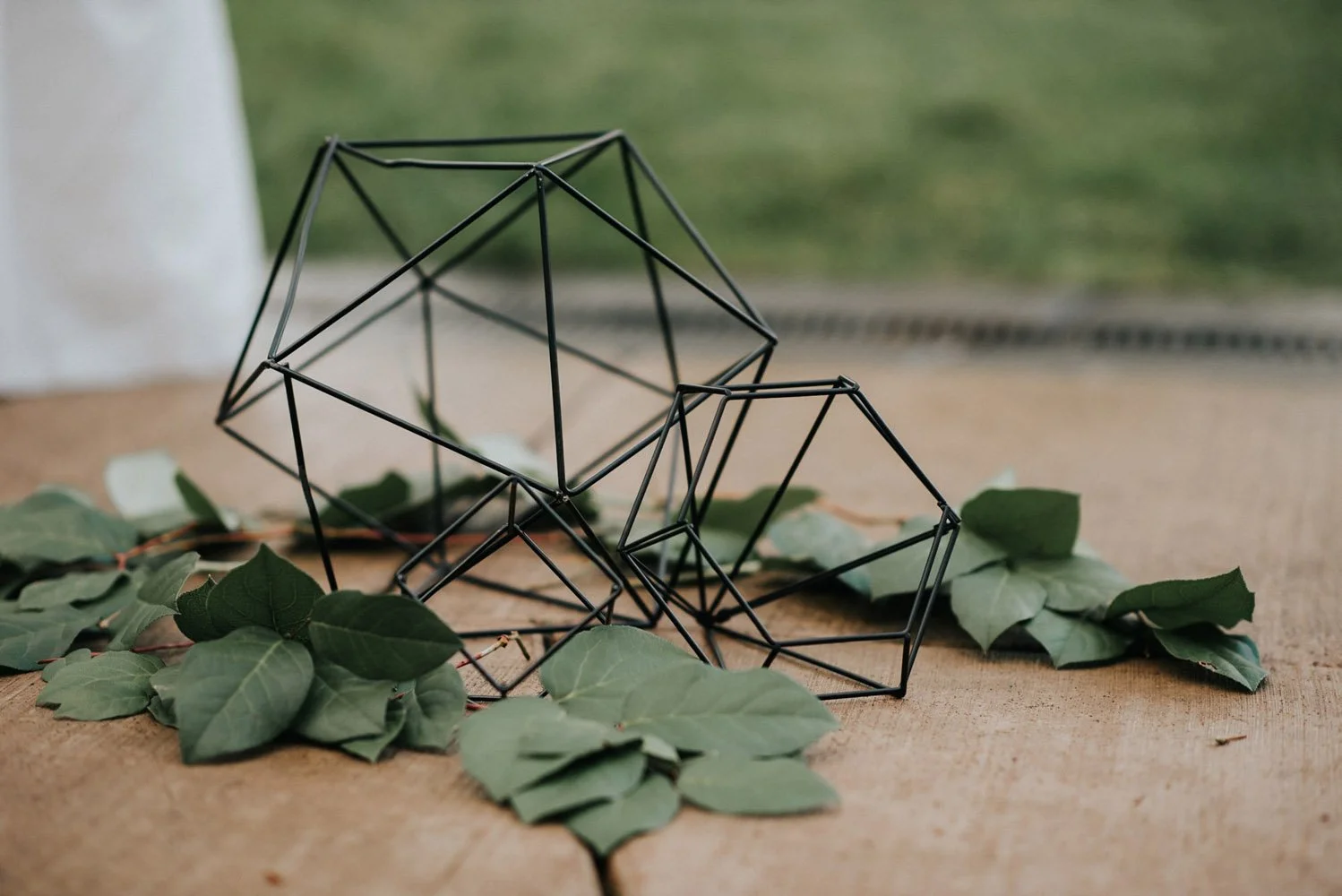 A black hexagonal centerpiece surrounded by greens for this gothic rainforest wedding at the Alderbrook Resort-Photography by Nick plus Danee Photography.-planned and designed by Simply Wed