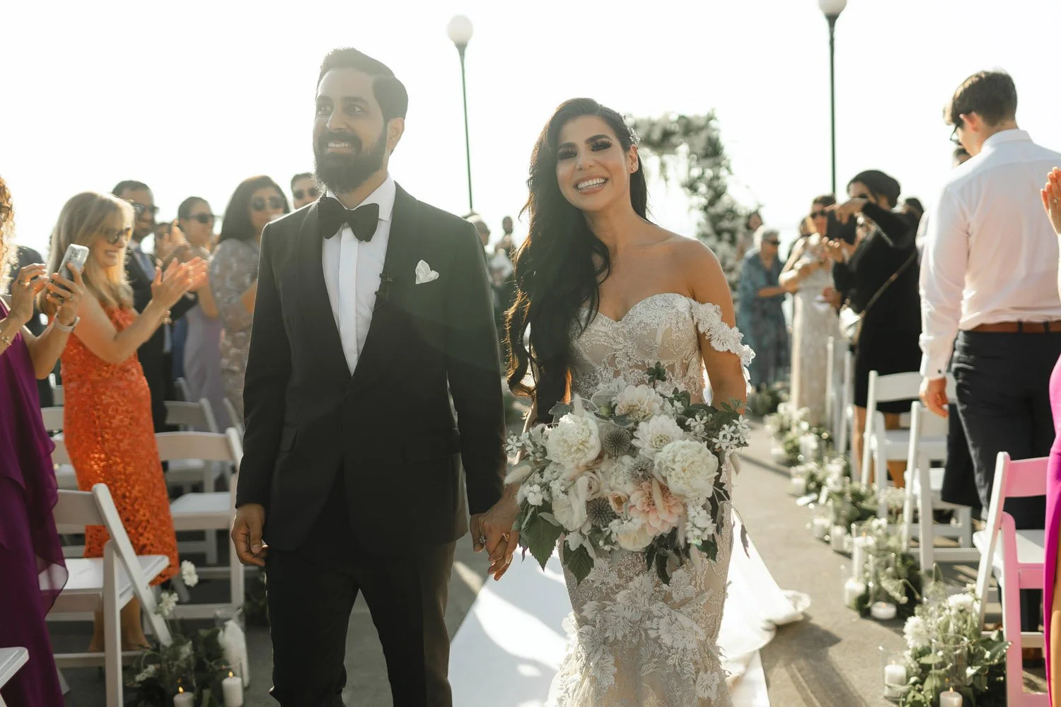The bride and groom exit ceremony hand and hand as husband and wife at the Seattle Aquarium-Photography by Precious Pics Photography-planned and designed by Simply Wed