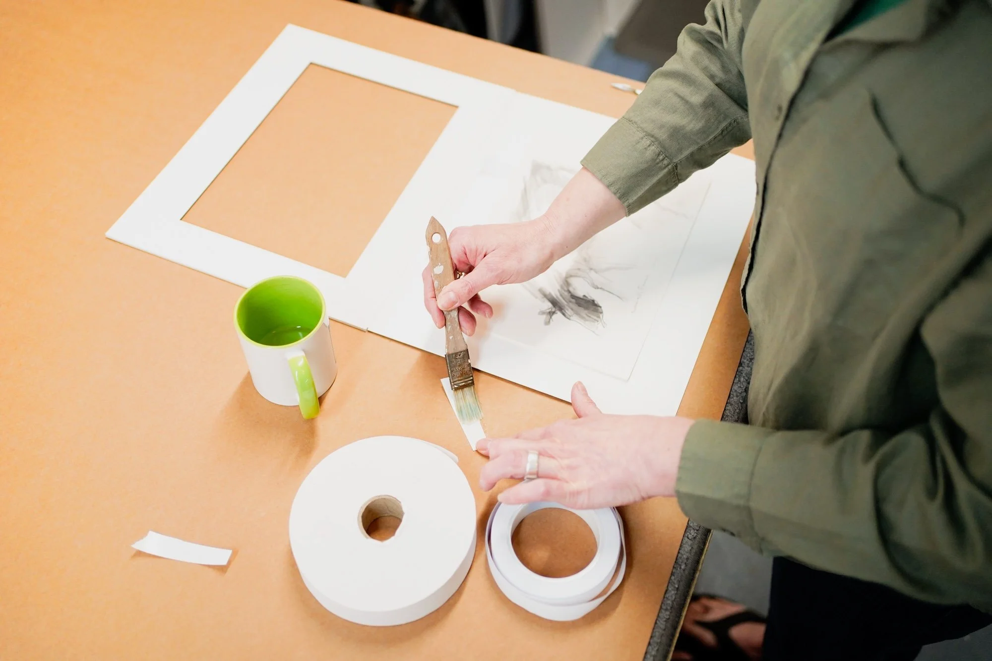 picture framer glueing picture frame on desk in Buckinghamshire