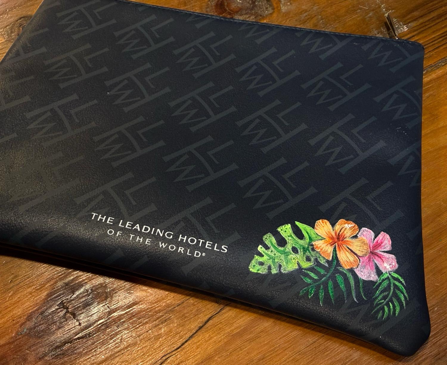 Hand painted floral design on travel pouch for bag painting activation in Manhattan