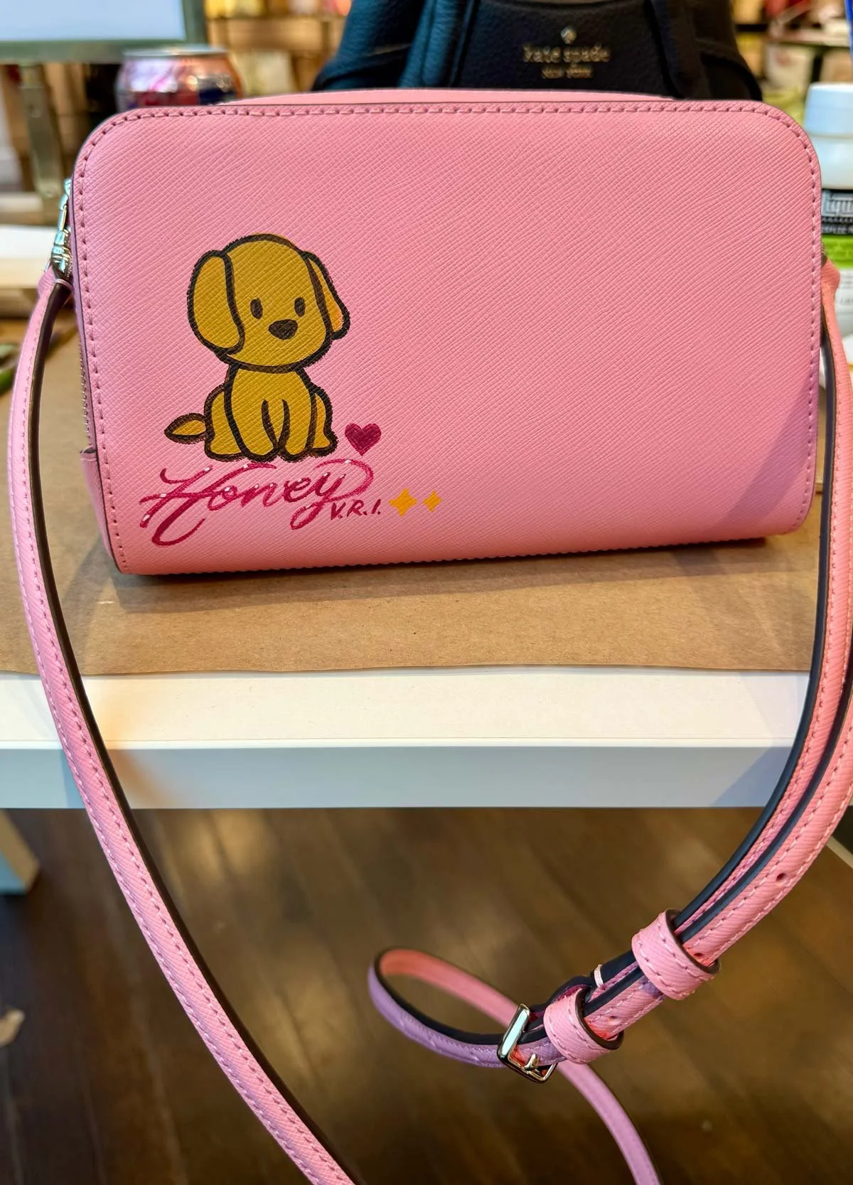 Super cute cartoon dog hand-painted on Kate Spade bag during SoCal activation