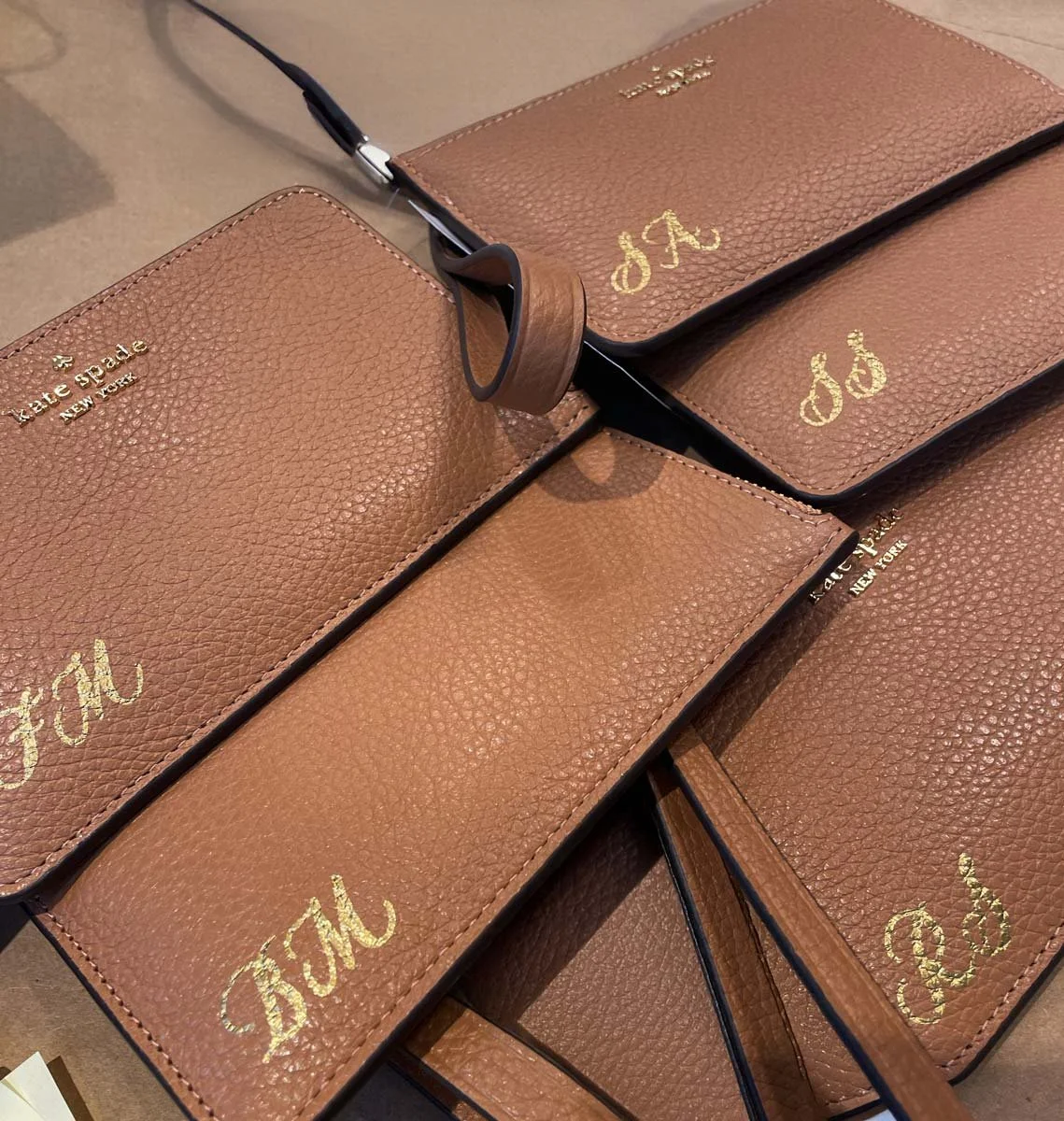 Live bag painting activation in Houston, Texas for Kate Spade. Calligraphy on leather women's wallets.