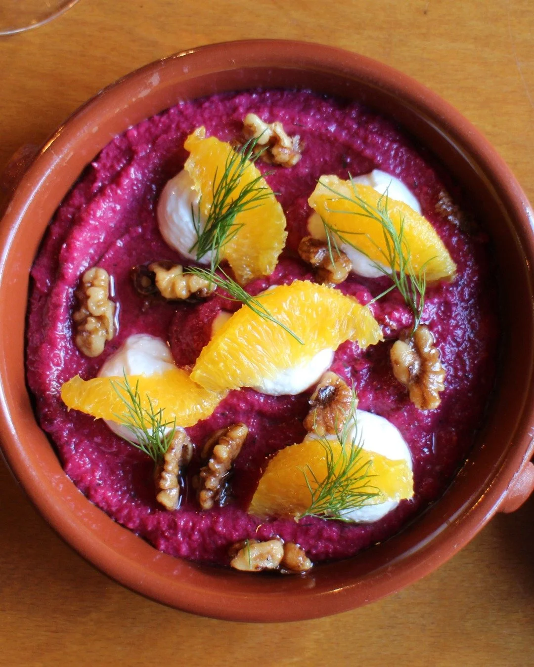 Just look at the colour on that! 

A twist on the classic Andalusian favourite, our creamy, earthy Beetroot Salmorejo is finished with orange, dill and walnuts for texture and freshness. Perfectly light, it goes beautifully with our warm Baker Tom's 