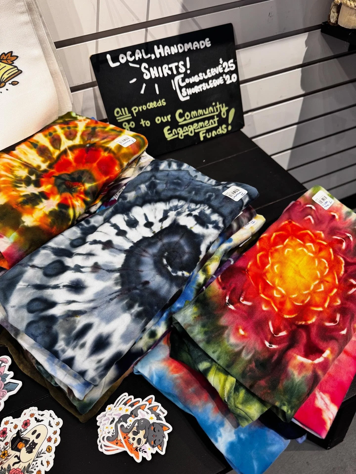 Hand-dyed tie-dye tees, made locally! Donated with love &mdash; every sale supports our Community Engagement Fund!