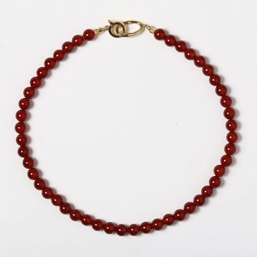 The NEW viva carnelian necklace. 

A true statement piece, this necklace has an oversized gold clasp that can be styled at the front for bold impact or at the back for a sleek finish. The vibrant orange carnelian adds a pop of colour, bringing warmth