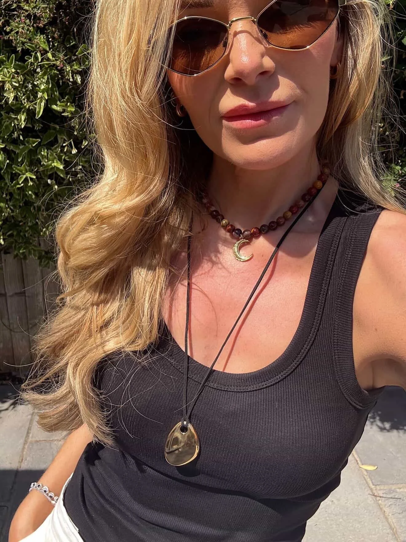 Double-layered necklaces, a simple black vest, and sunshine to make the whole look glow, effortless and classic. 

Love how @georgina_patient has put this look together with the Mooakite Esmeray necklace and gold pendant.