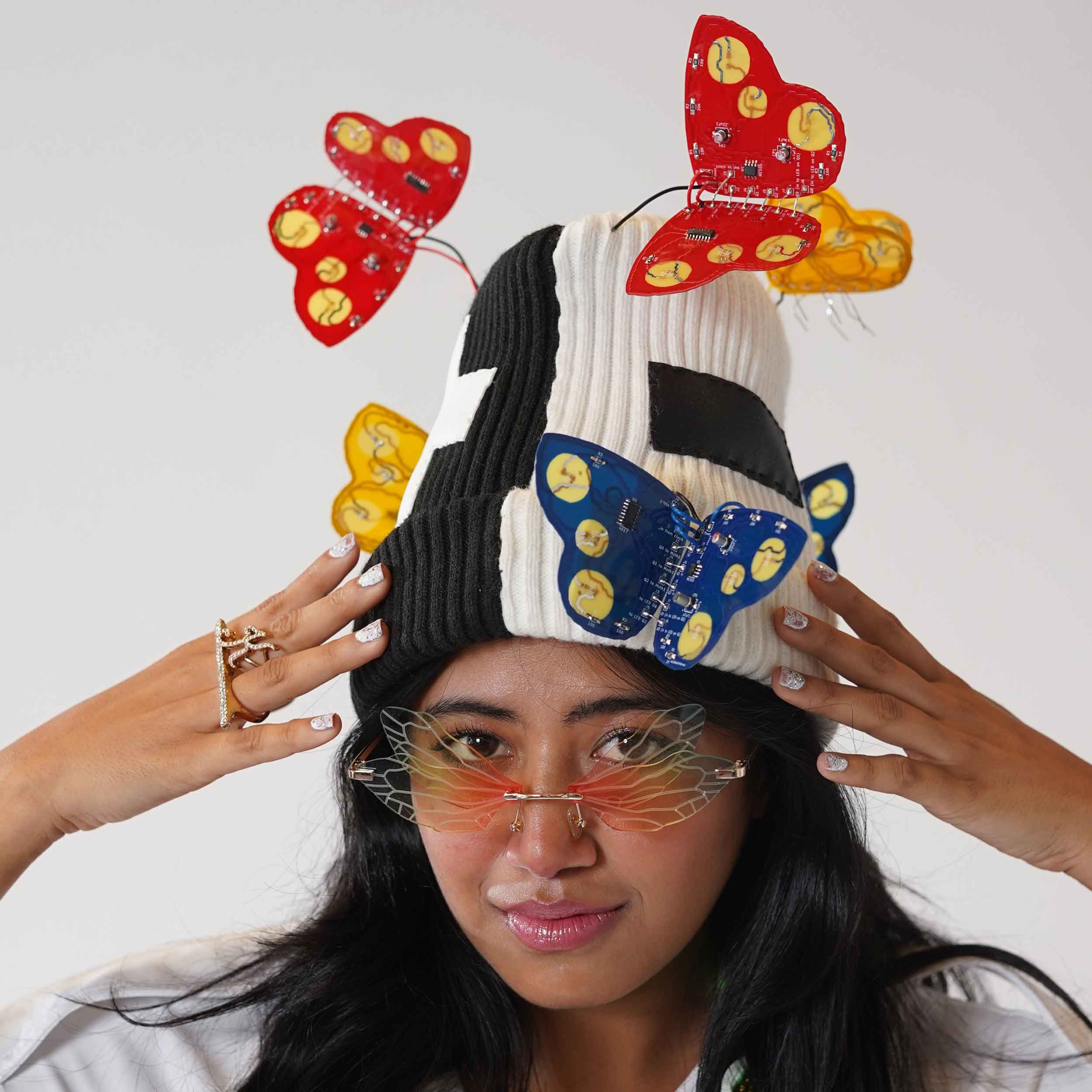Model wearing Kelly Heaton's polar beanie covered in electronic butterflies