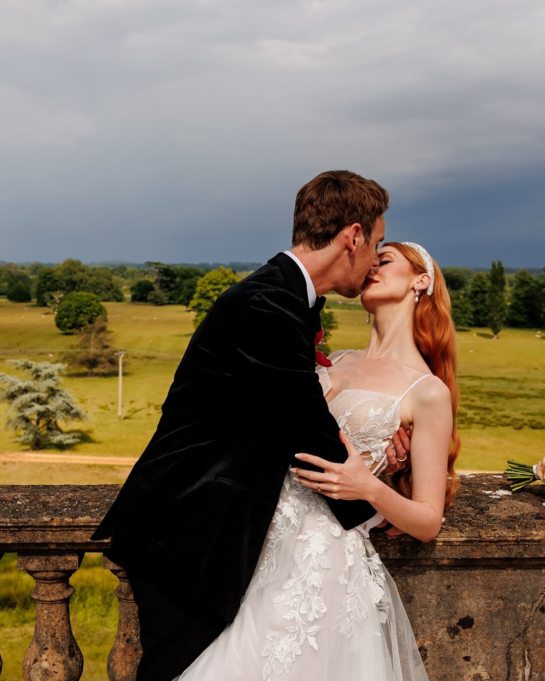 ✨ A Kiss to Remember ✨
Under dramatic skies and surrounded by the sweeping views of Somerley, our real-life couple @togetherwithmarkandnic shared a cinematic moment worthy of the silver screen. From the elegant lace details of the @littlelondonbrides