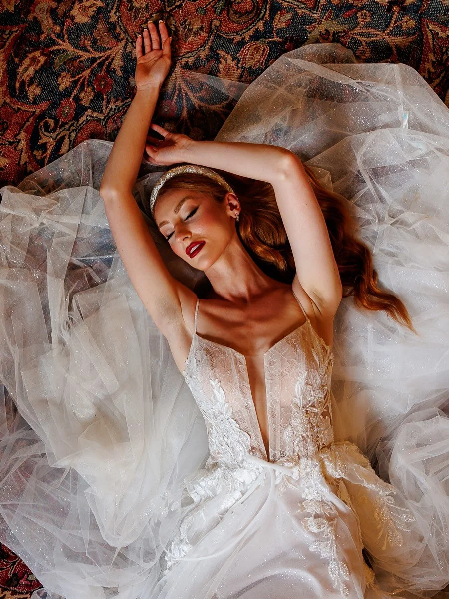 Not just a bride&mdash;a vision.

Editorial meets elegance in this moment of calm, captured with intention. Lying in layers of tulle and texture, she owns the space completely&mdash;graceful, powerful, and utterly timeless.

Because bridal portraits 