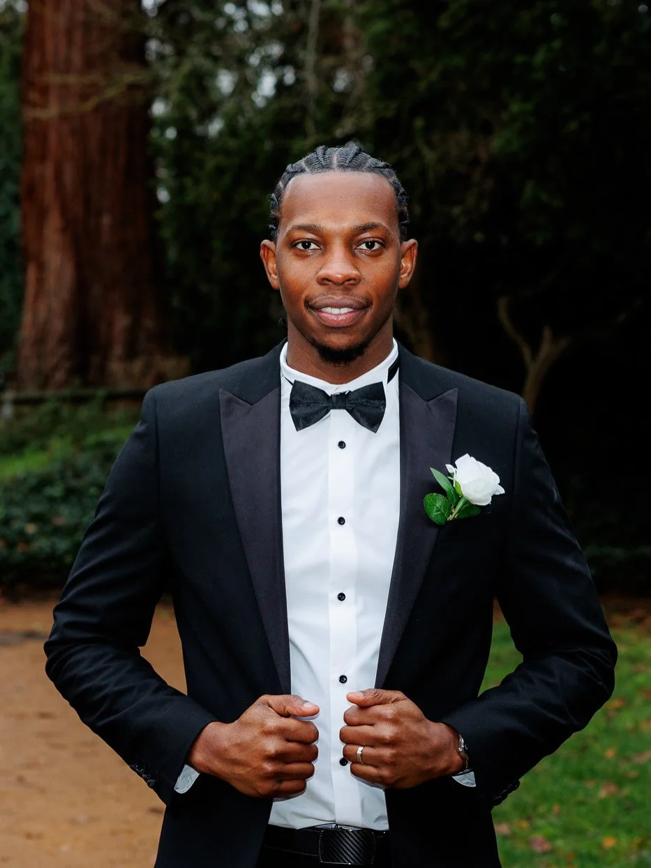 The groomsman absolutely owning the moment.
Sharp tux. Confident stance. And those incredible ruins behind him.
When you&rsquo;ve got history like Abingdon Abbey Ruins as your backdrop, you make the most of it. Clean singular portraits of the groom, 