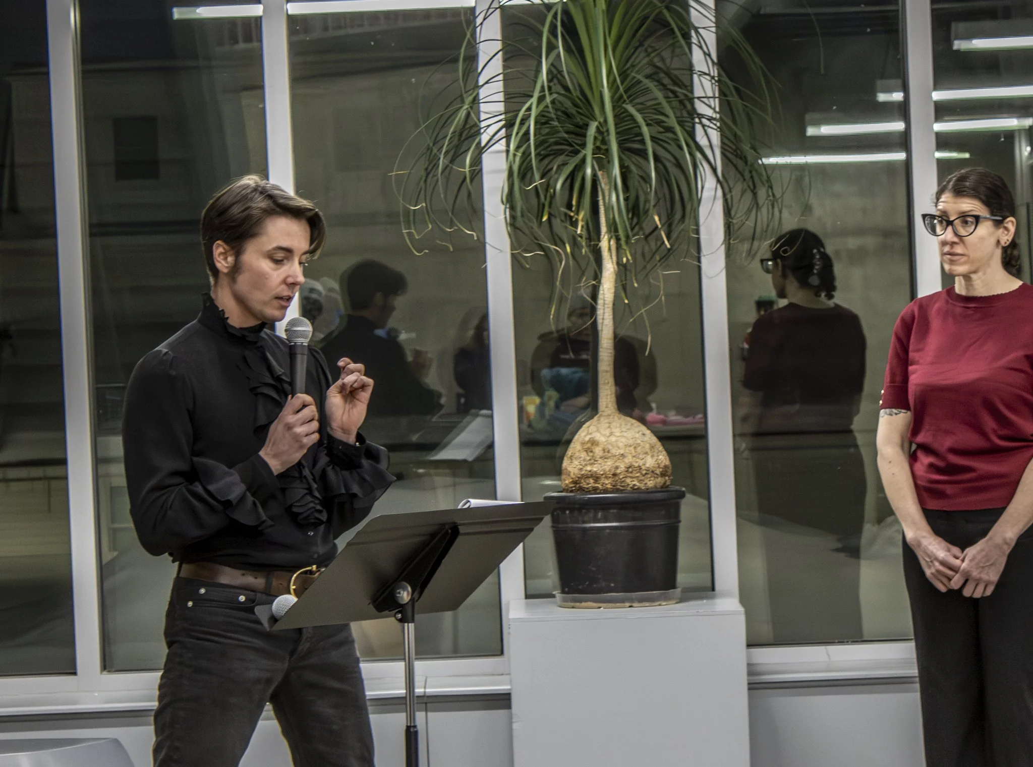 Luca Mellon discusses experience with incarcerated individuals with curator, Nicole Lund, looking on. 
