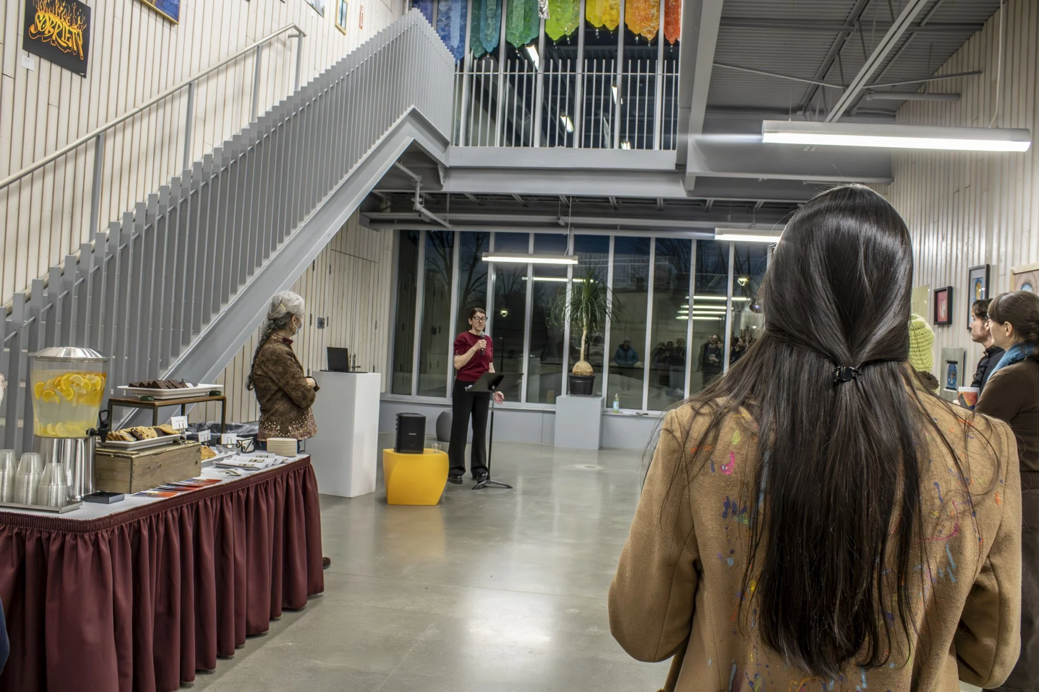 Curator Nicole Lund introduces the Inside Vision art show at the opening reception.