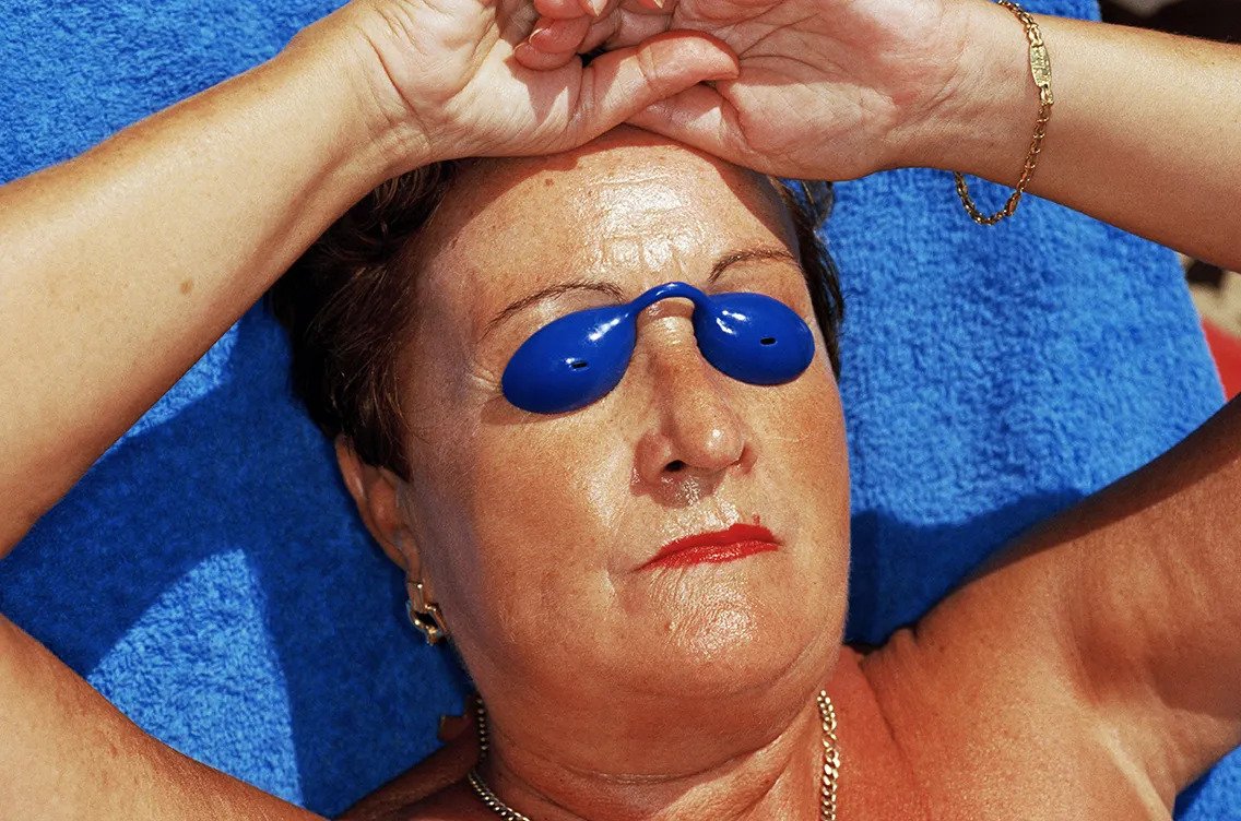 Martin Parr color photography Woman with blue summer at the beach.jpg
