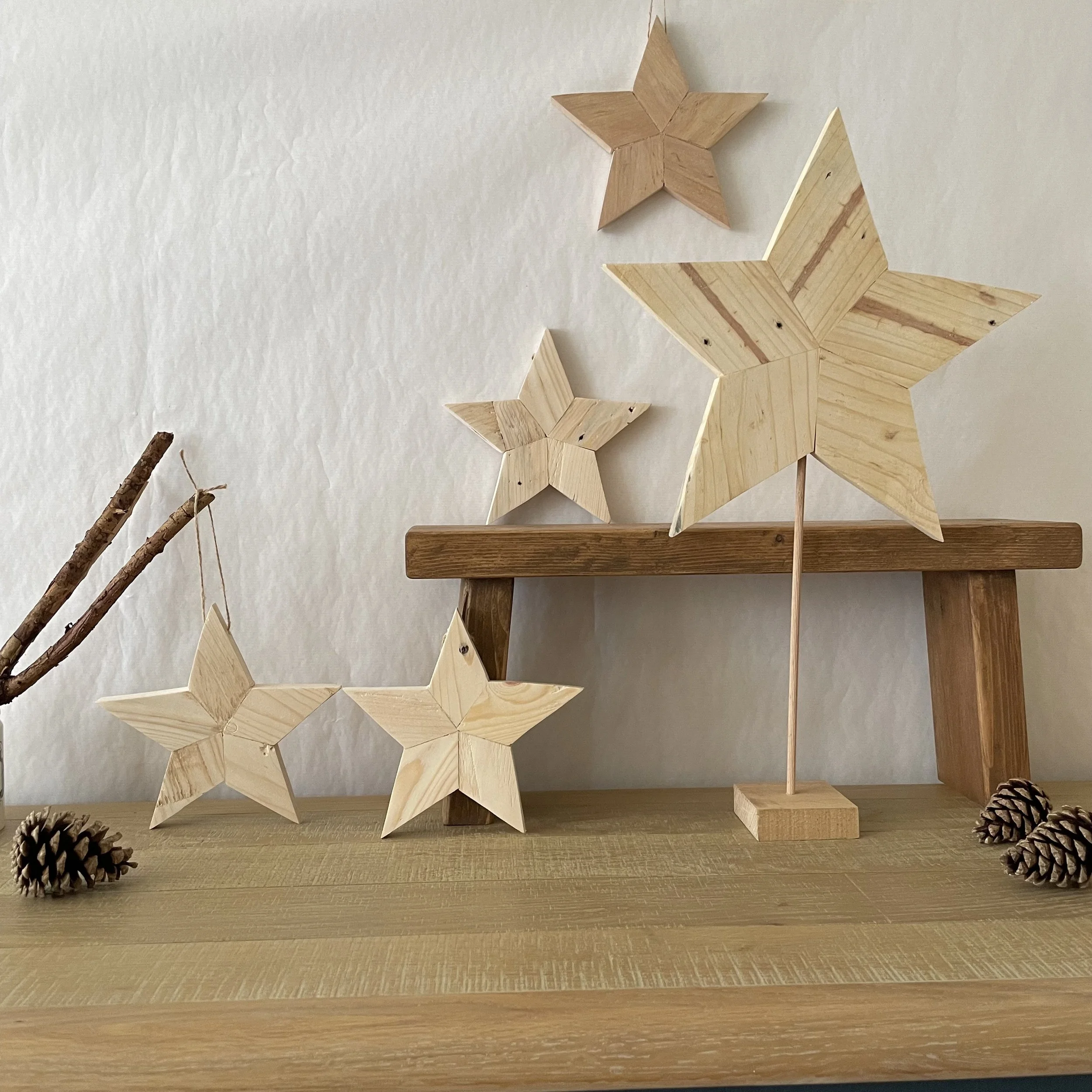 Wooden handing stars and Christmas tree on wood stand